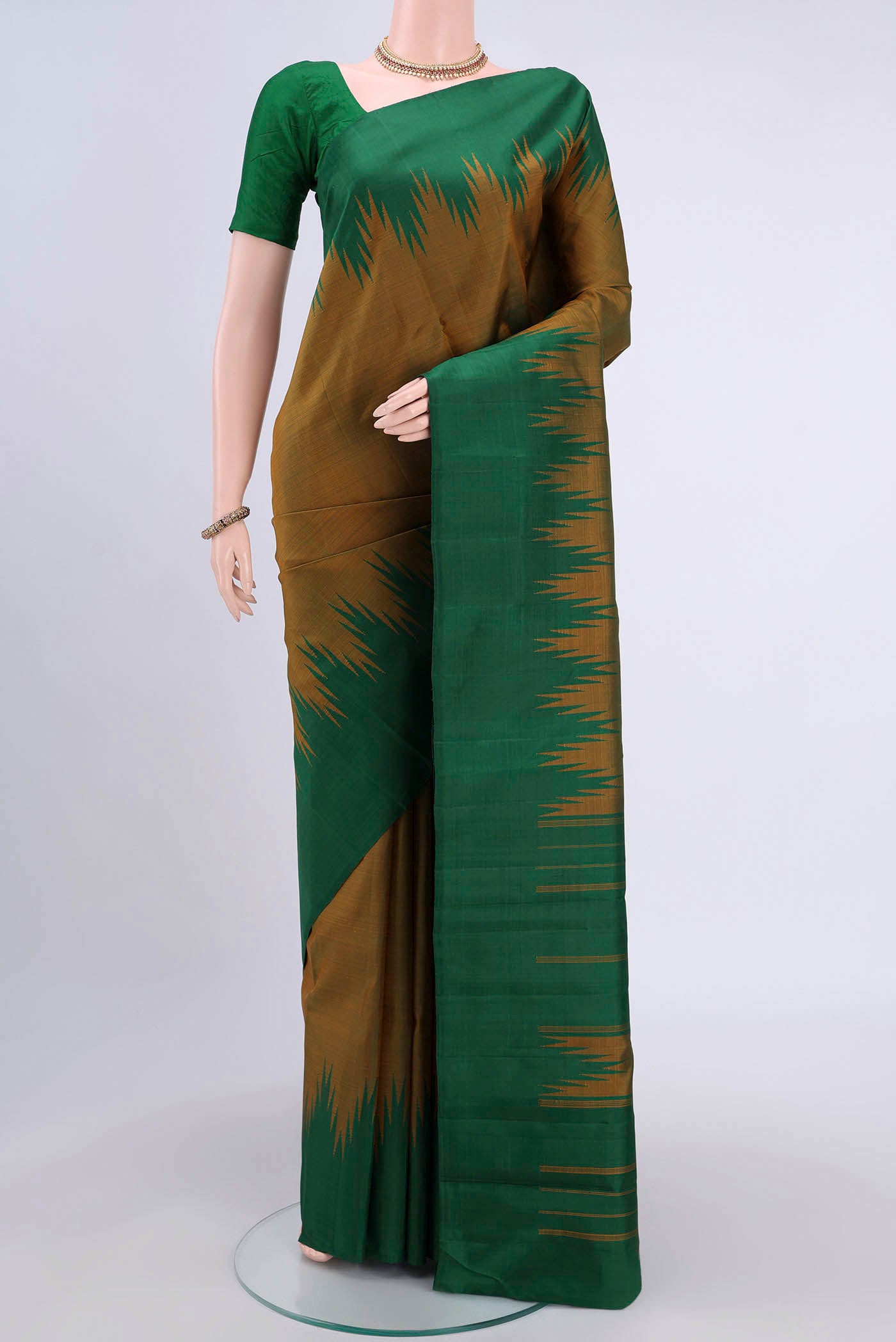 Mehandi Green Kanchipuram Silk Saree with Plain Body and Rising Temple Border displayed on a mannequin