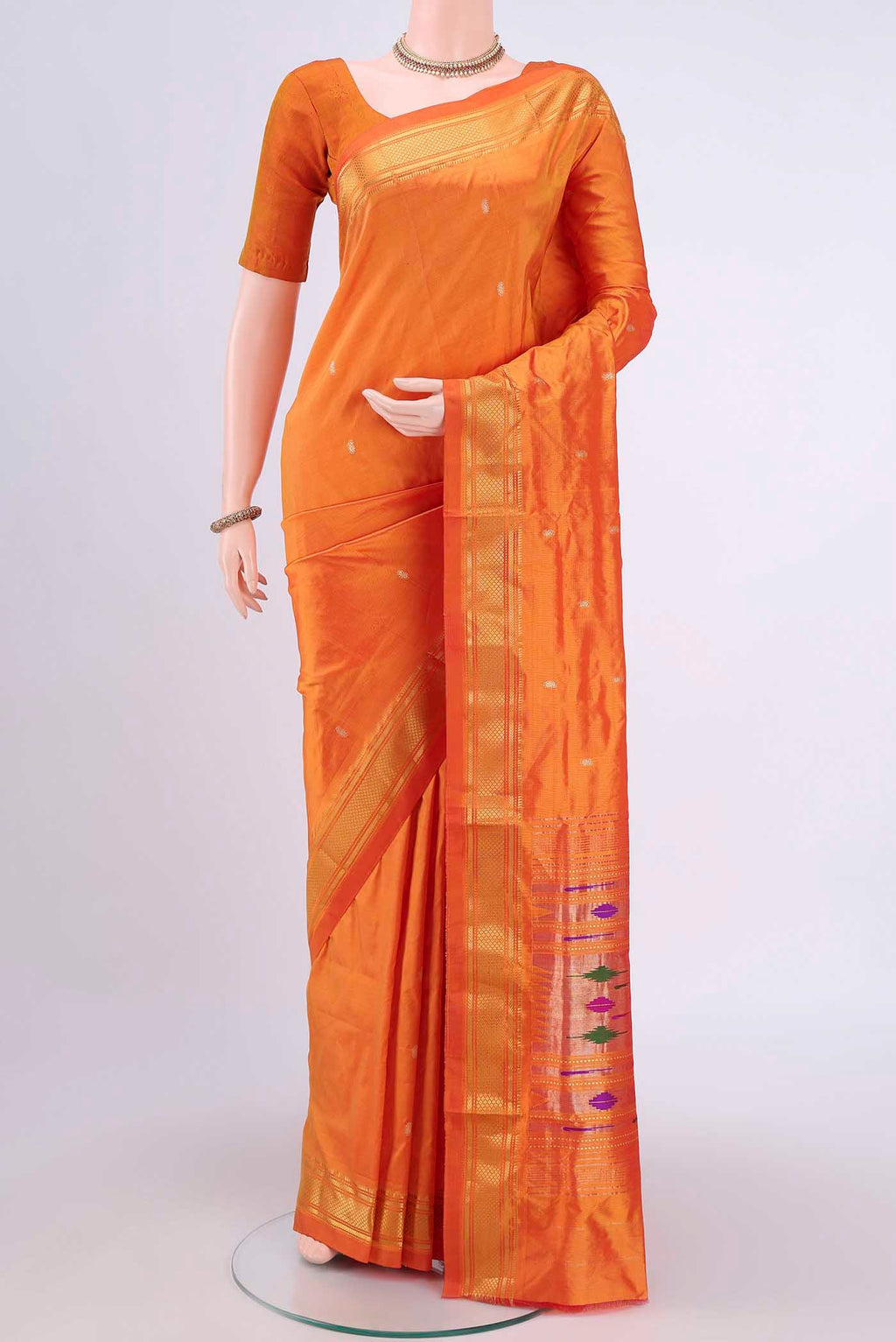 Brick Orange Paithani Silk Saree with Zari Butta on the body and Zari Border.  displayed on a mannequin