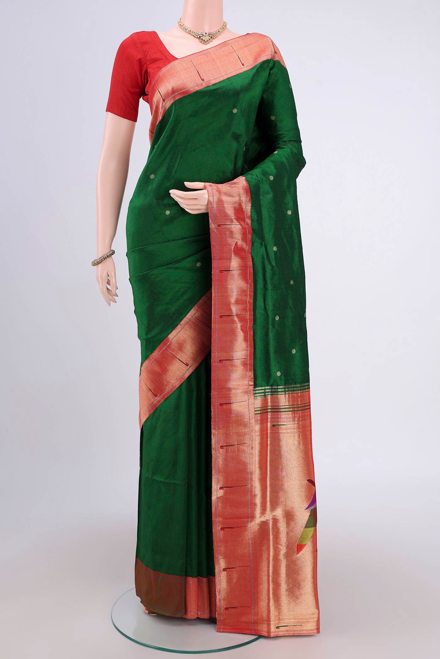 Green Soft Silk Saree with Zari Butta on the body and Zari Border.  displayed on a mannequin