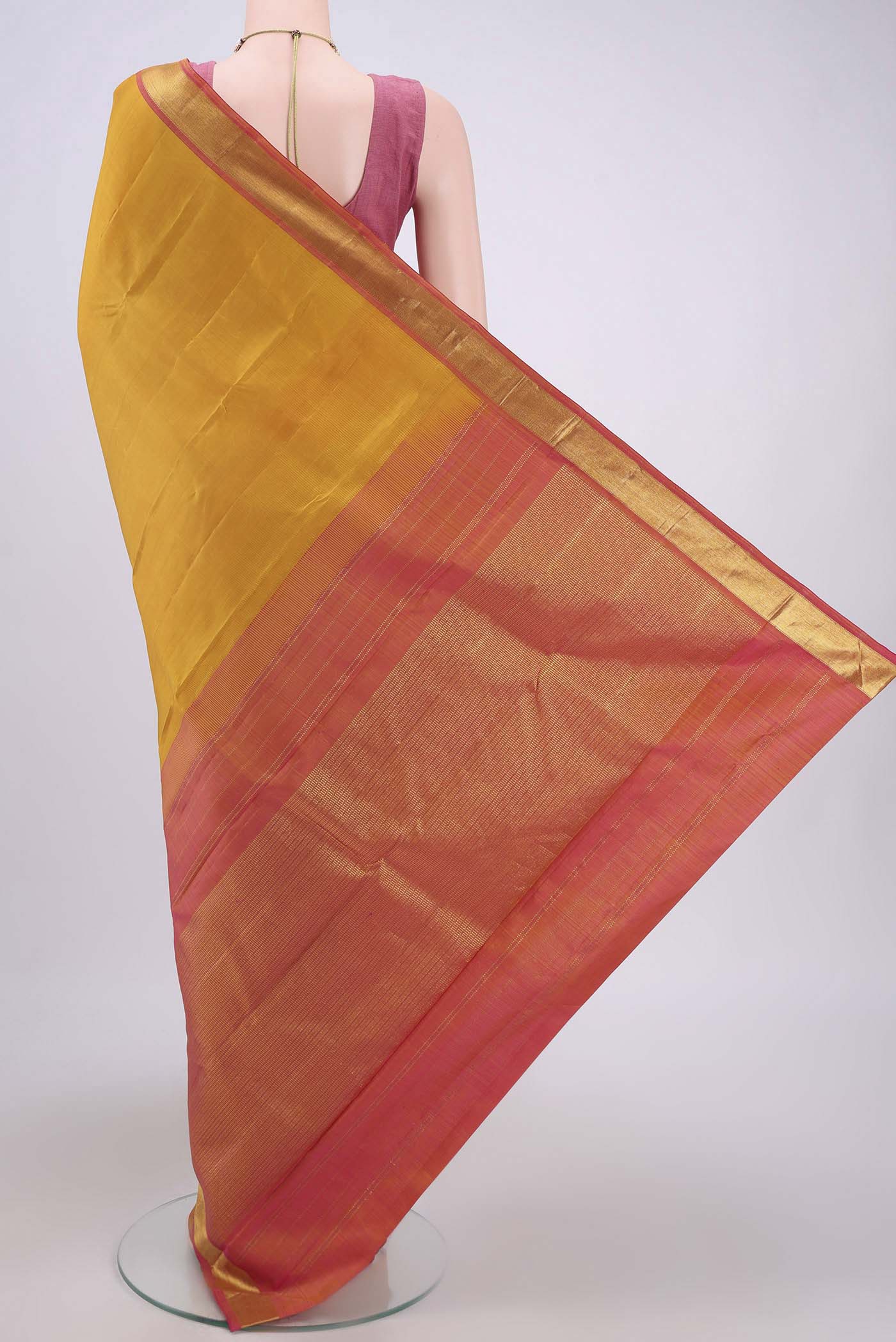 Flat view of Yellow Kanjivaram Saree with Plain Body and Zari Border. 