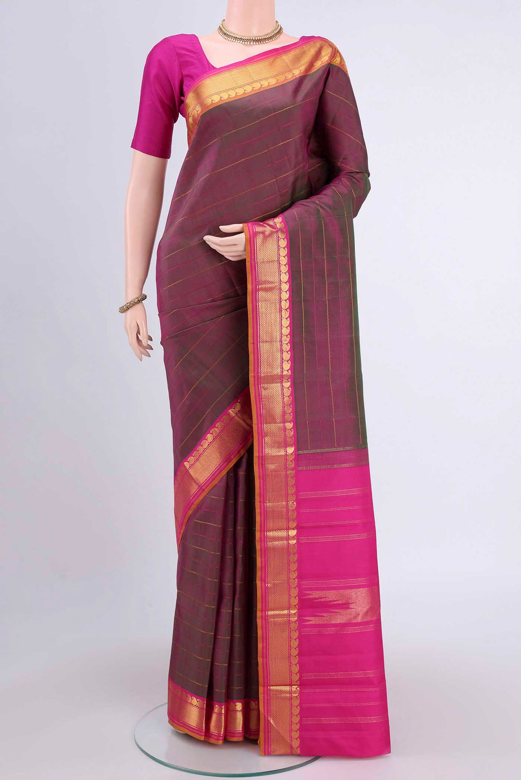 Light Magenta Kanchipuram Saree with Stripes on the body and Zari Border.  displayed on a mannequin