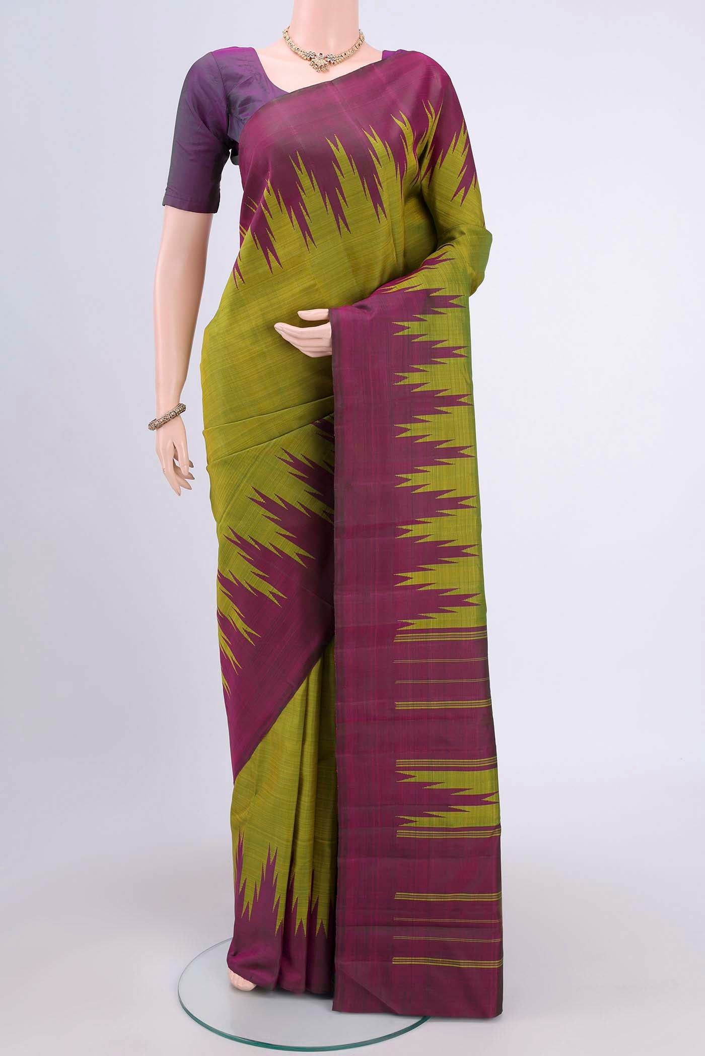 Light Green Kanchipuram Saree with Plain Body and Temple Border displayed on a mannequin