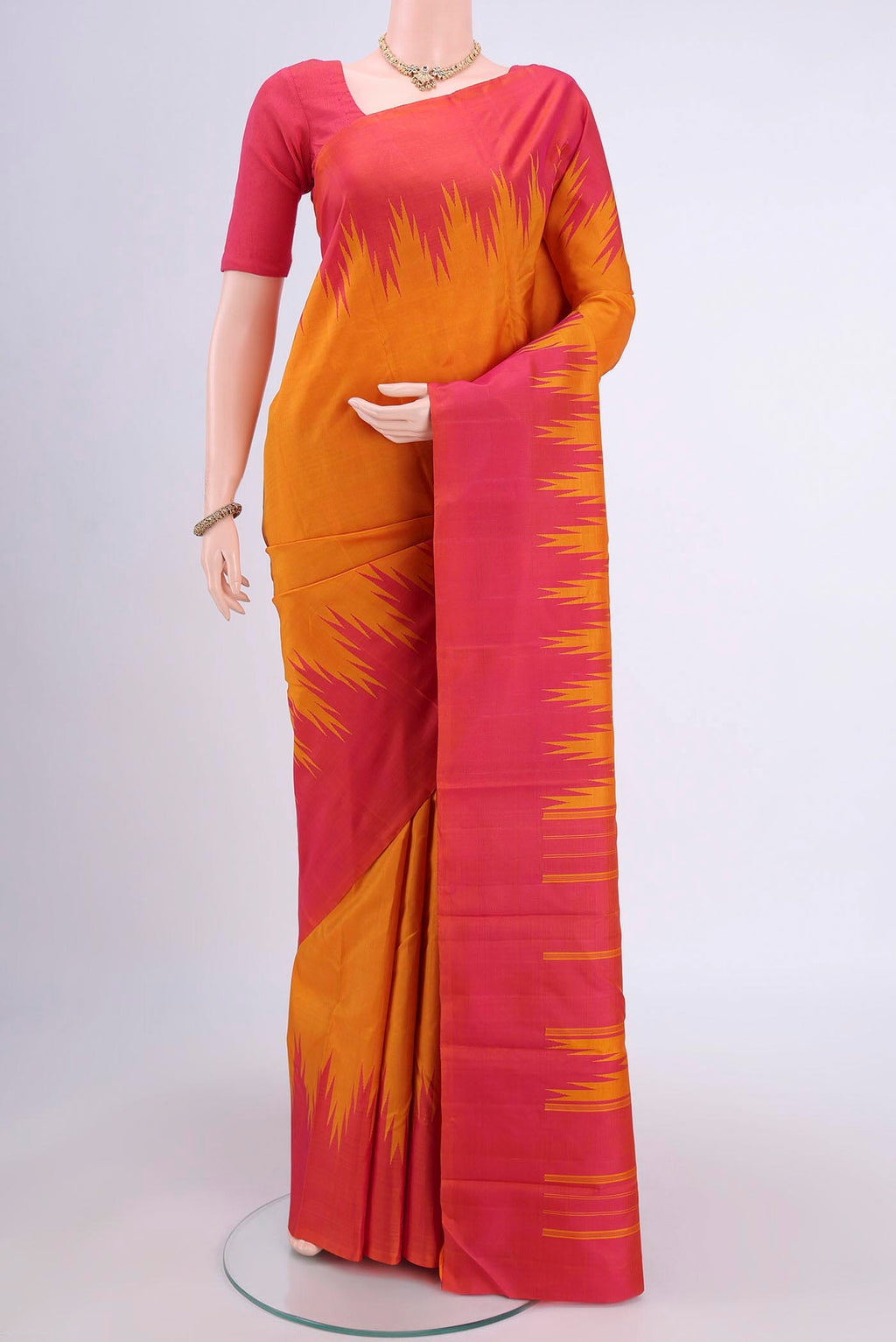 Mustard Kanchipuram Saree with Plain Body and Temple Border.  displayed on a mannequin