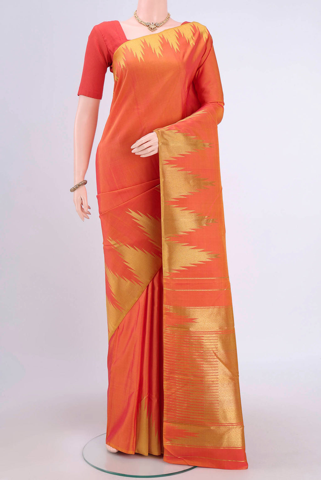 Pure Silk Pure Zari Brick Orange Dual Tone Kanchipuram Saree with Plain Body and Temple Border.  displayed on a mannequin