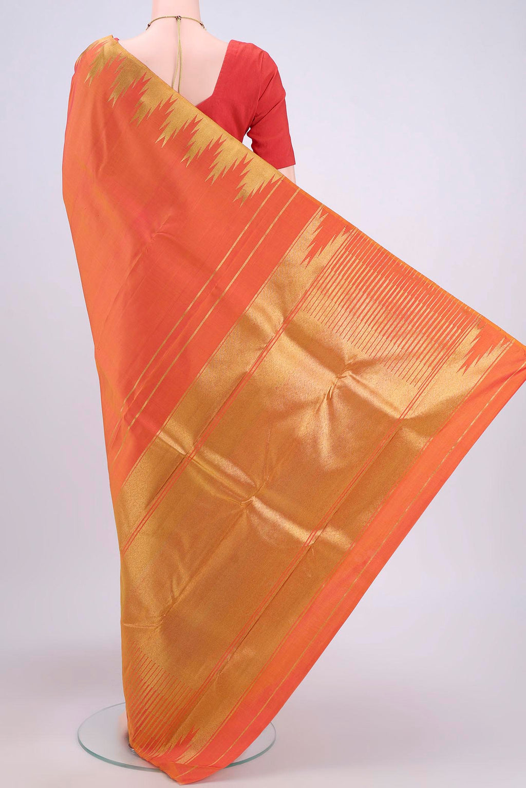 Flat view of Pure Silk Pure Zari Brick Orange Dual Tone Kanchipuram Saree with Plain Body and Temple Border. 