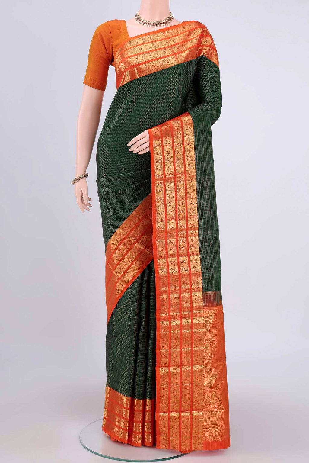 Bottle Green Dual Tone Kanchipuram Saree with Checked design on the body and Zari Border.  displayed on a mannequin