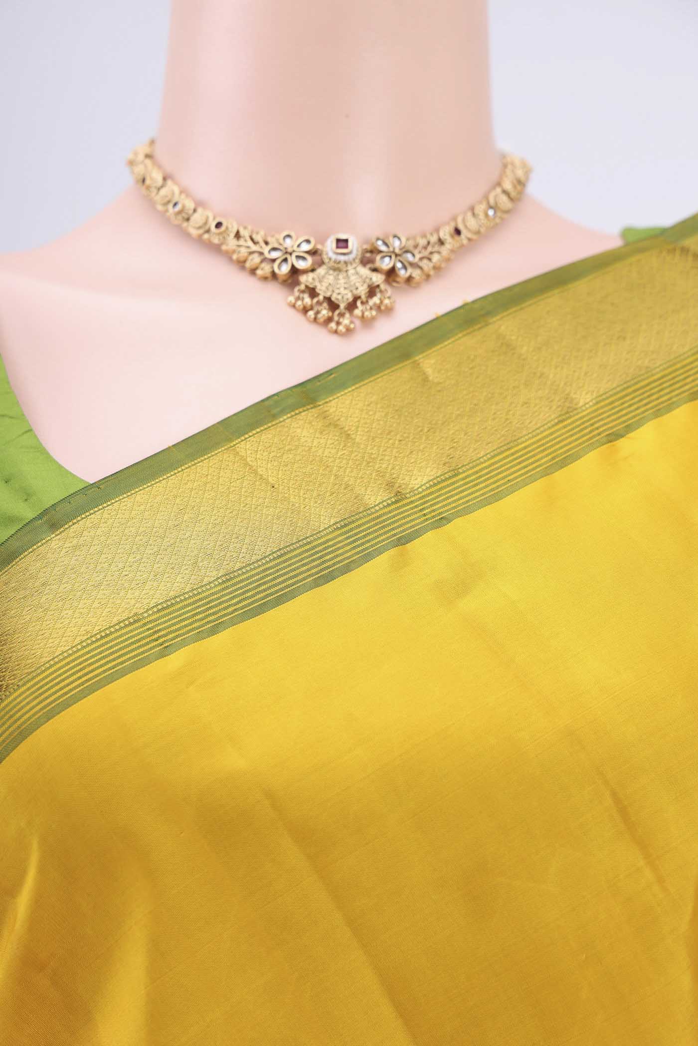 Border image of Lemon Yellow Dual Tone Kanjivaram Saree with Plain Body and Zari Border. 