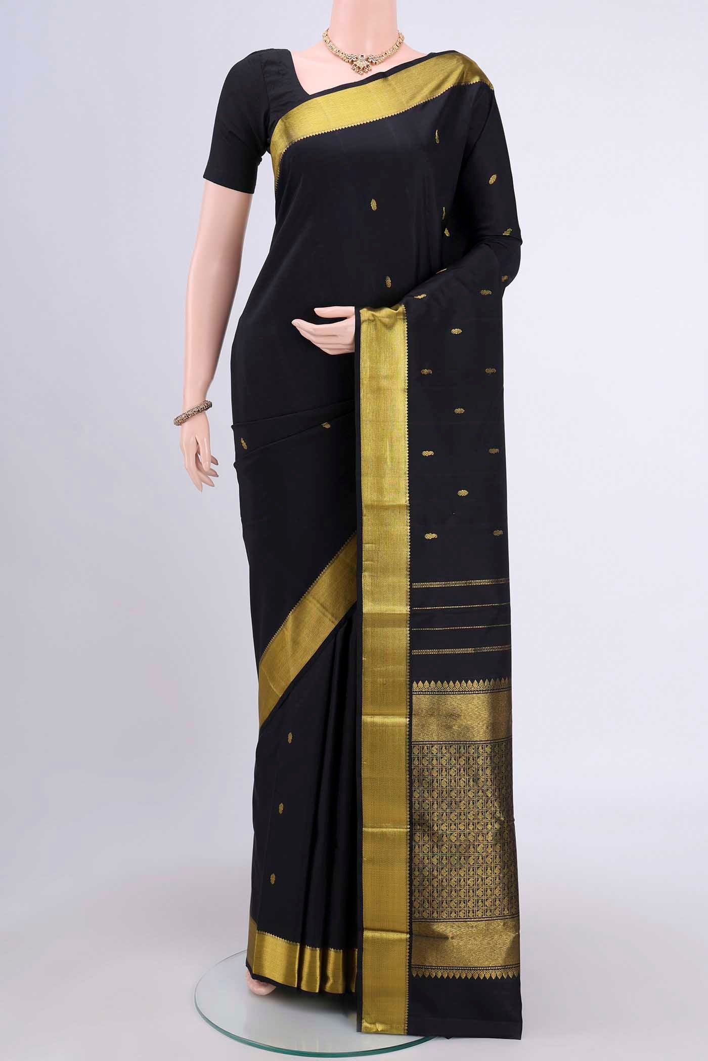 Black Kanchipuram Saree with Zari Butta on the body and Zari Border.  displayed on a mannequin