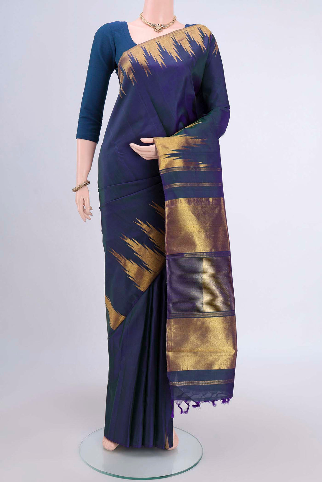 Peacock Blue Kanjivaram Saree with Plain Body and Temple Border.  displayed on a mannequin