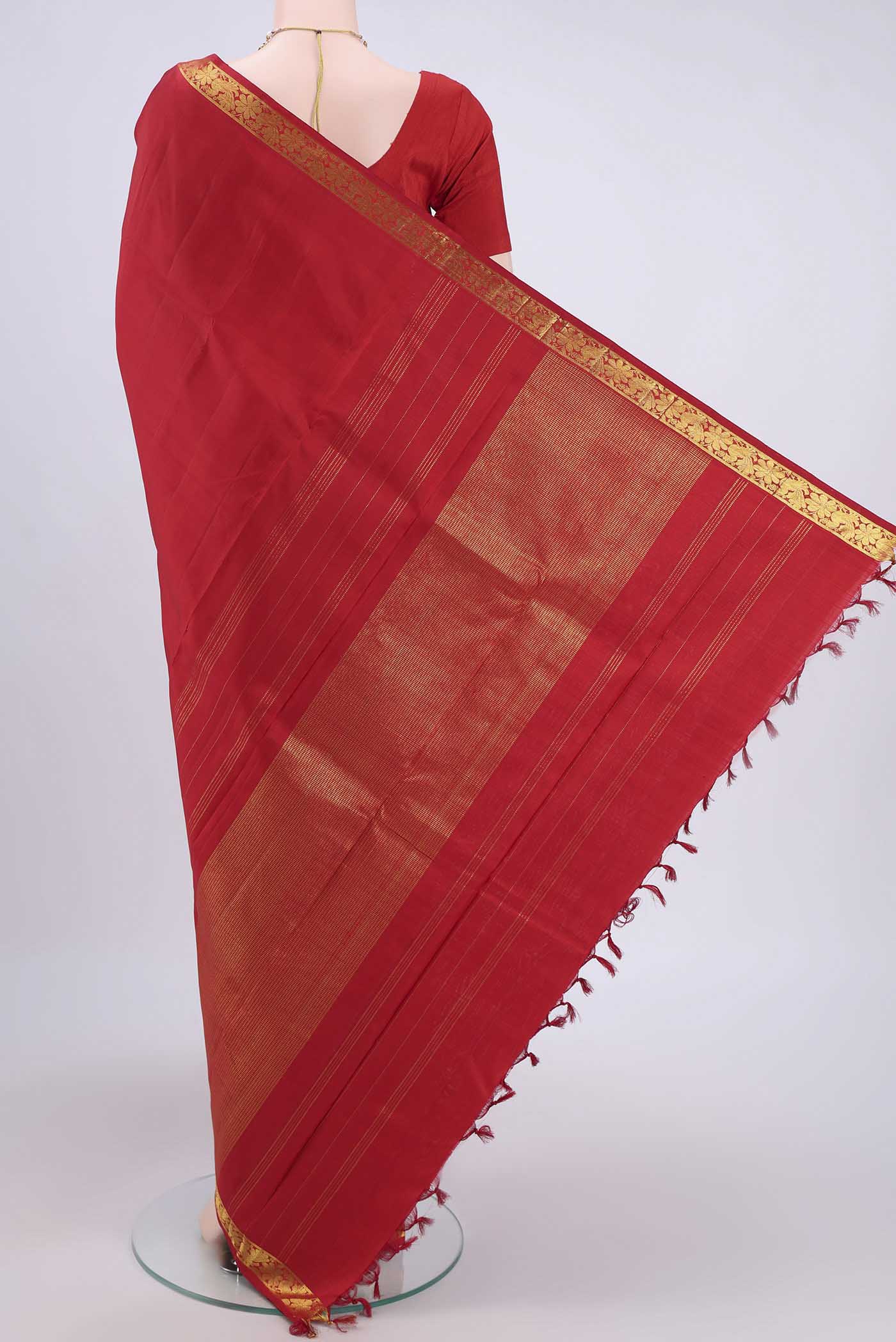 Flat view of Red Kanjivaram Saree with Plain Body and Zari Border. 
