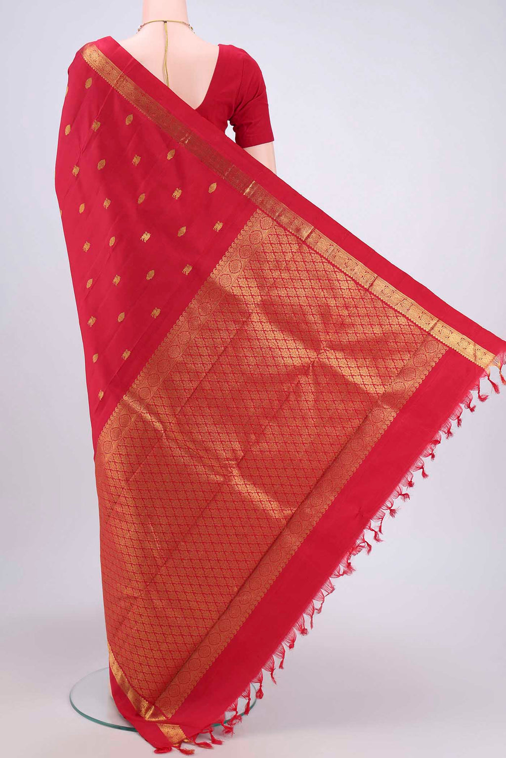Flat view of Red Kanchipuram Saree with Zari Butta on the body and Zari Border. 