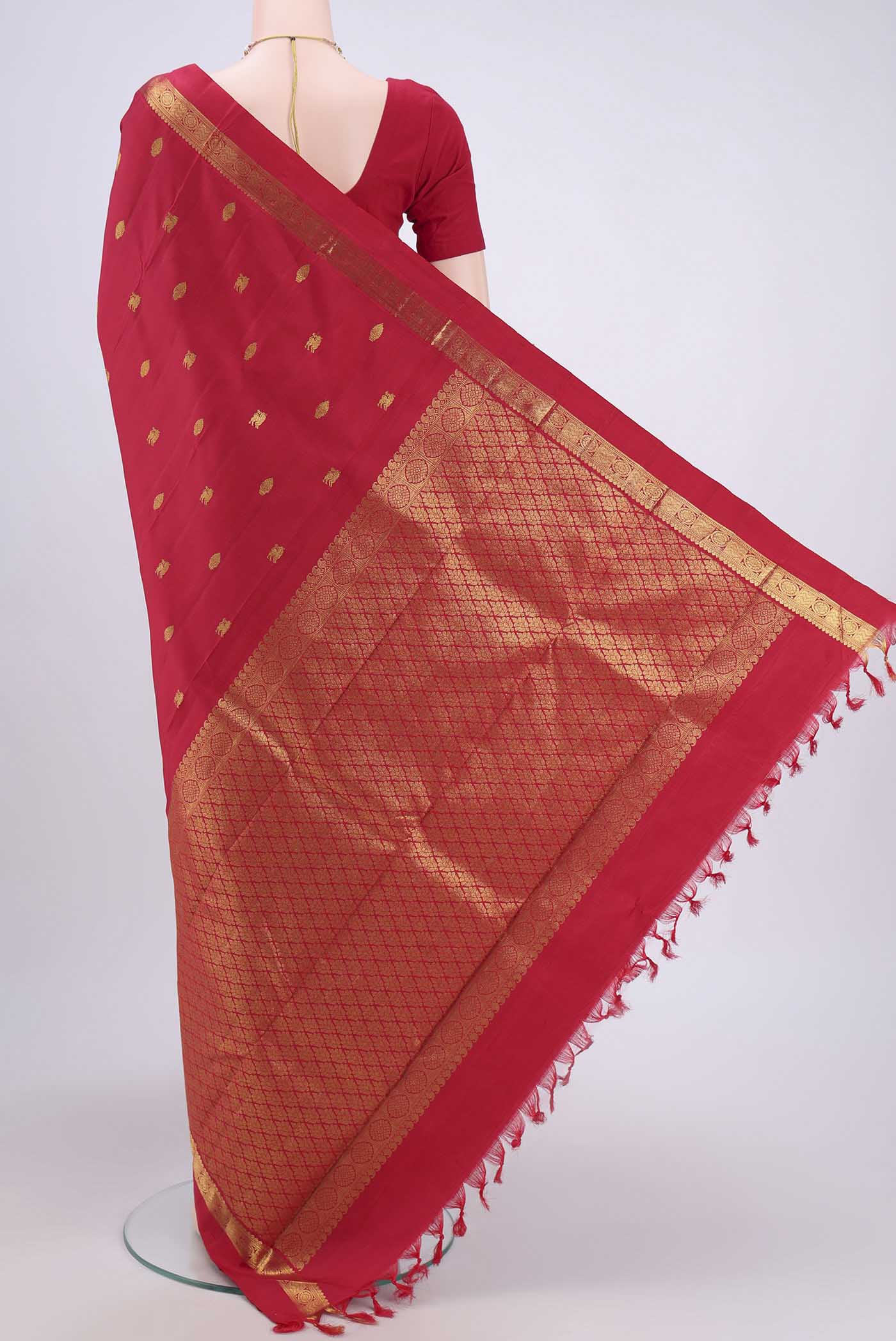 Flat view of Red Kanchipuram Saree with Zari Butta on the body and Zari Border. 