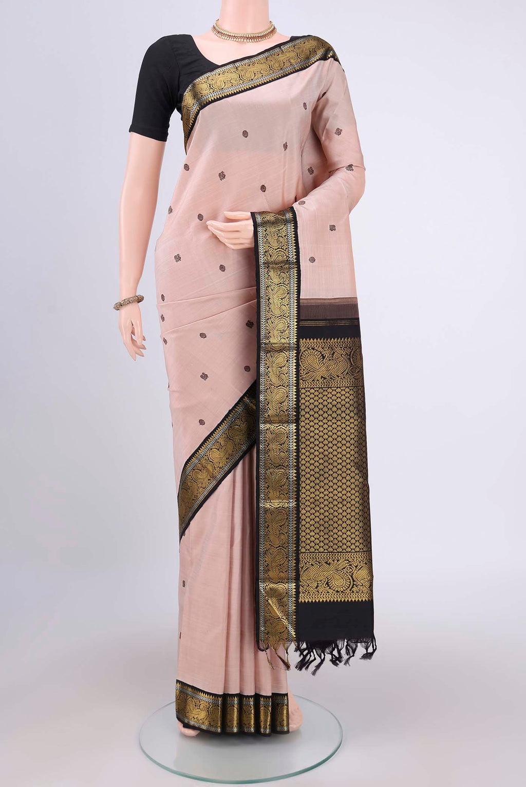 Peach Dual Tone Kanjivaram Silk Saree with Thread Butta on the body and Zari Border.  displayed on a mannequin