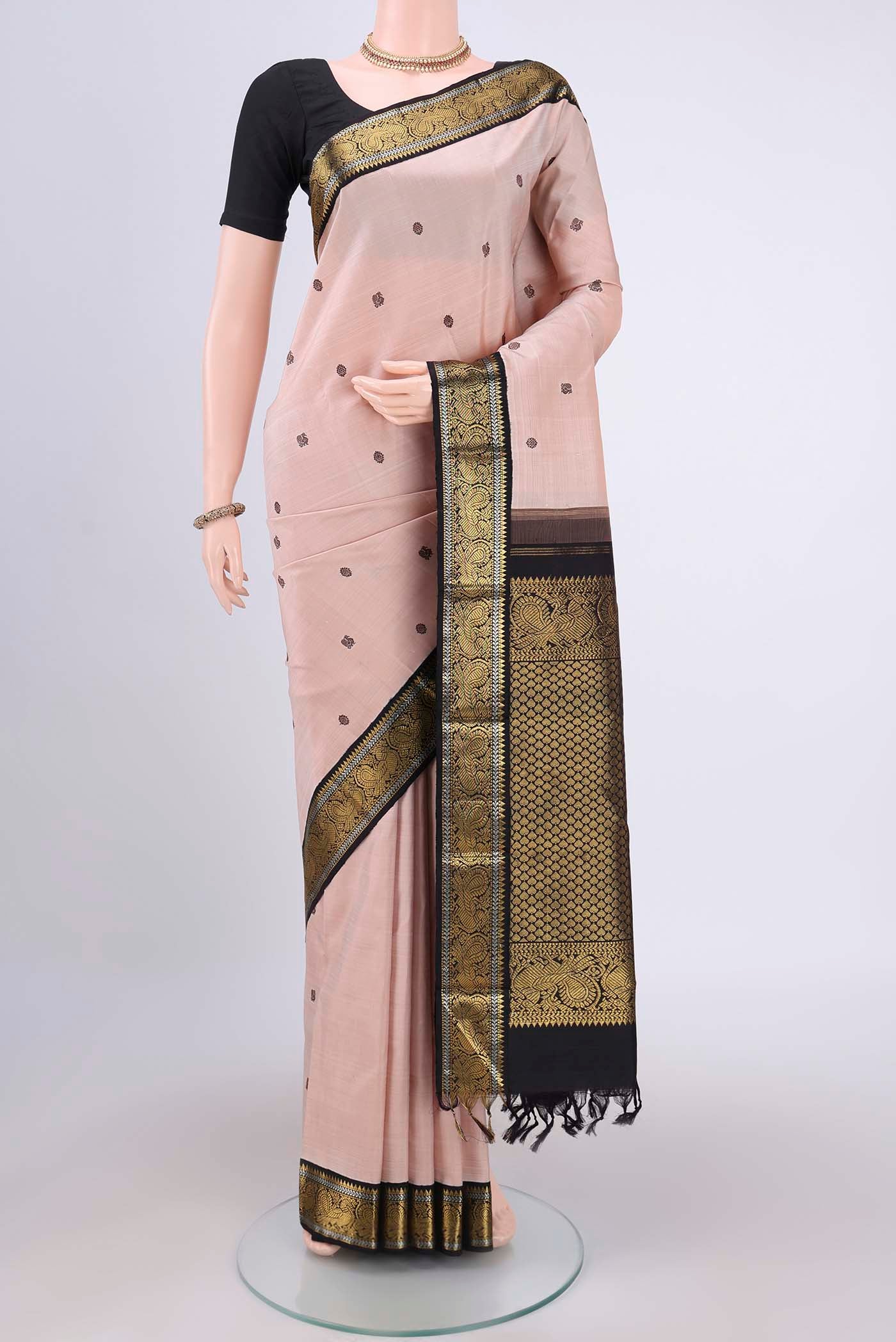 Peach Dual Tone Kanjivaram Silk Saree with Thread Butta on the body and Zari Border.  displayed on a mannequin