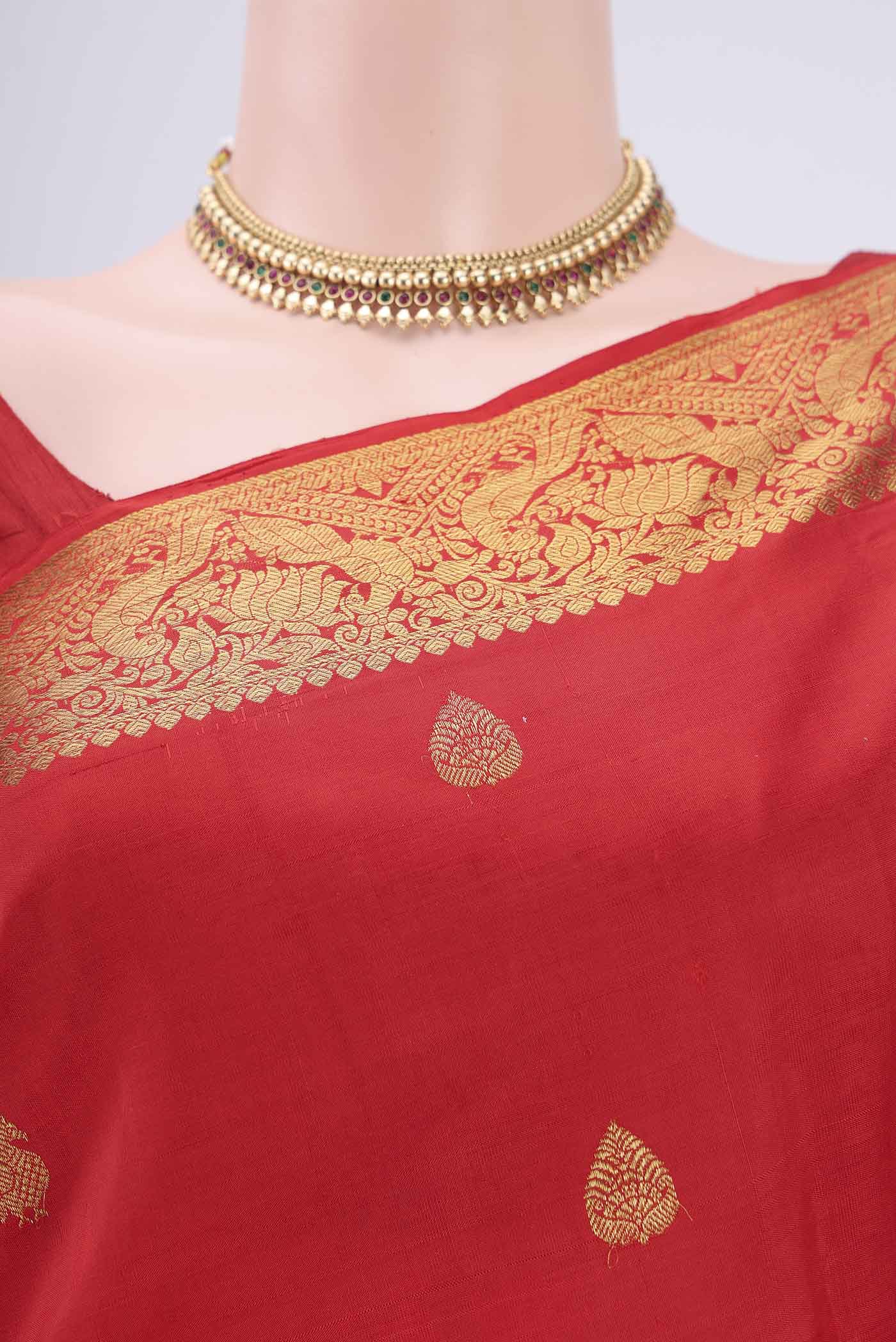 Border image of Red Kanjivaram Saree with Zari Butta on the body and Zari Border. 