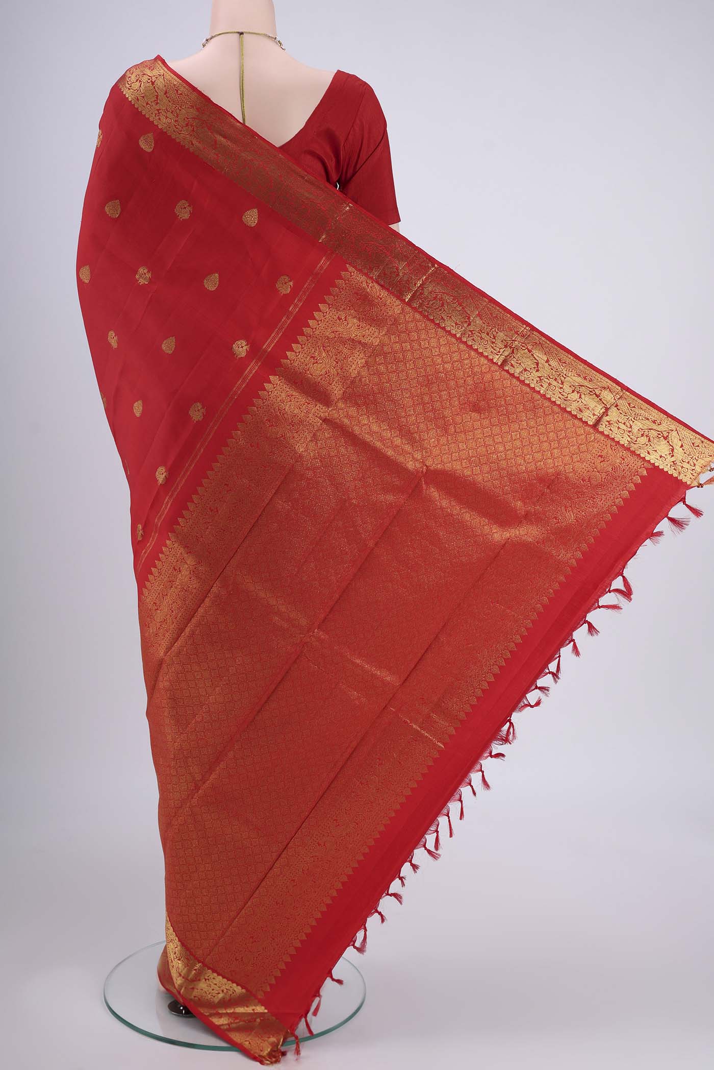Flat view of Red Kanjivaram Saree with Zari Butta on the body and Zari Border. 