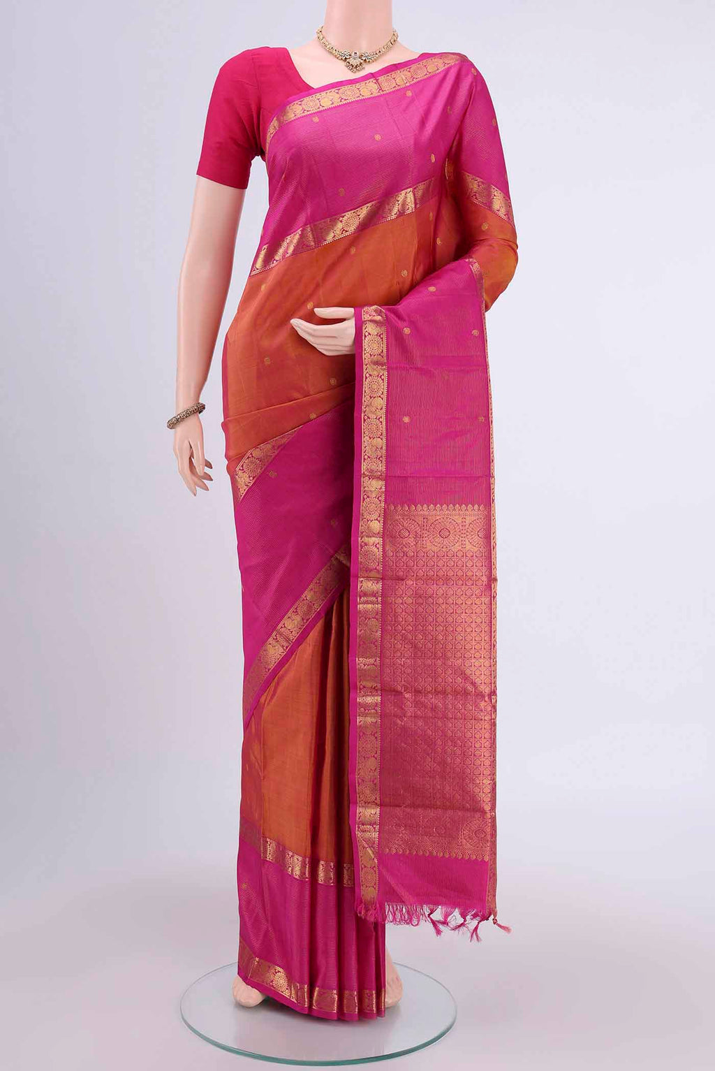 Brick Orange Kanchipuram Saree with Zari Butta on the body and Zari Border displayed on a mannequin