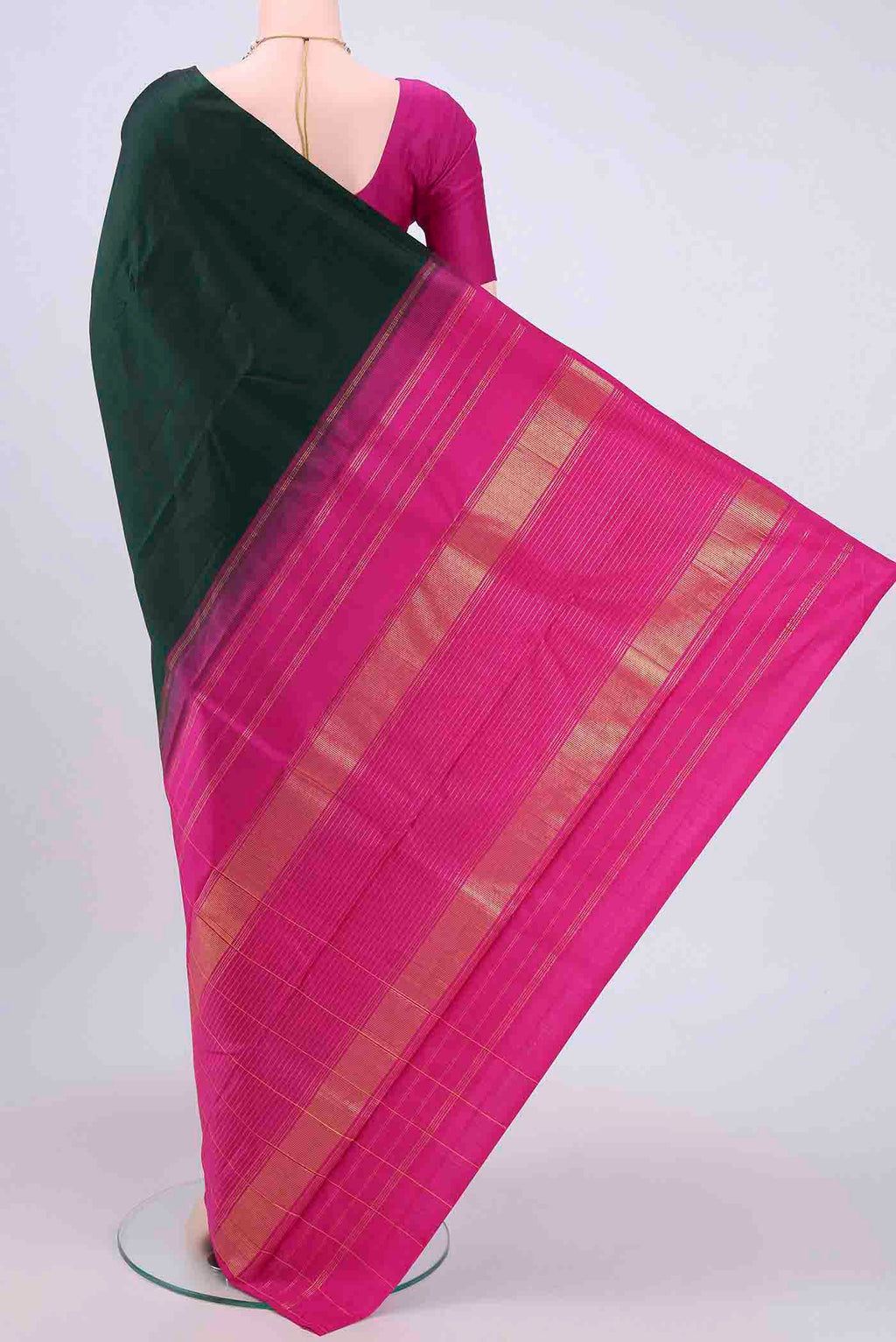 Flat view of Bottle Green Kanchipuram Saree with Zari Butta on the body and Zari Border. 