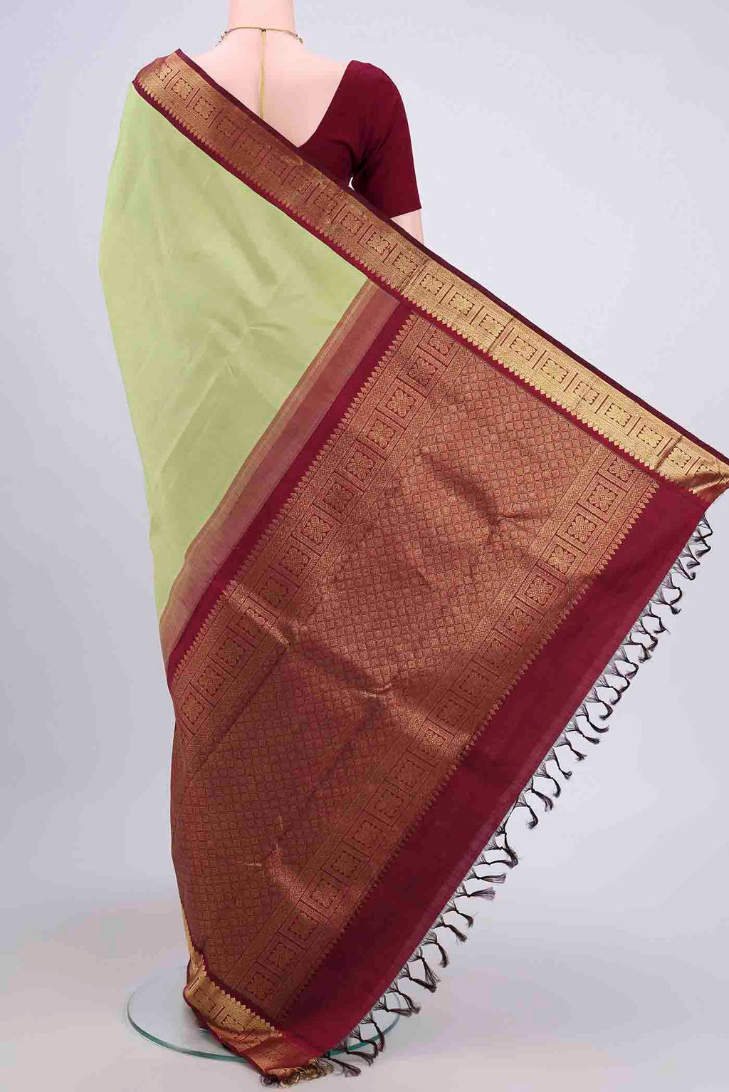 Flat view of Acid Green Kanjivaram Saree with Plain Body and Zari Border. 