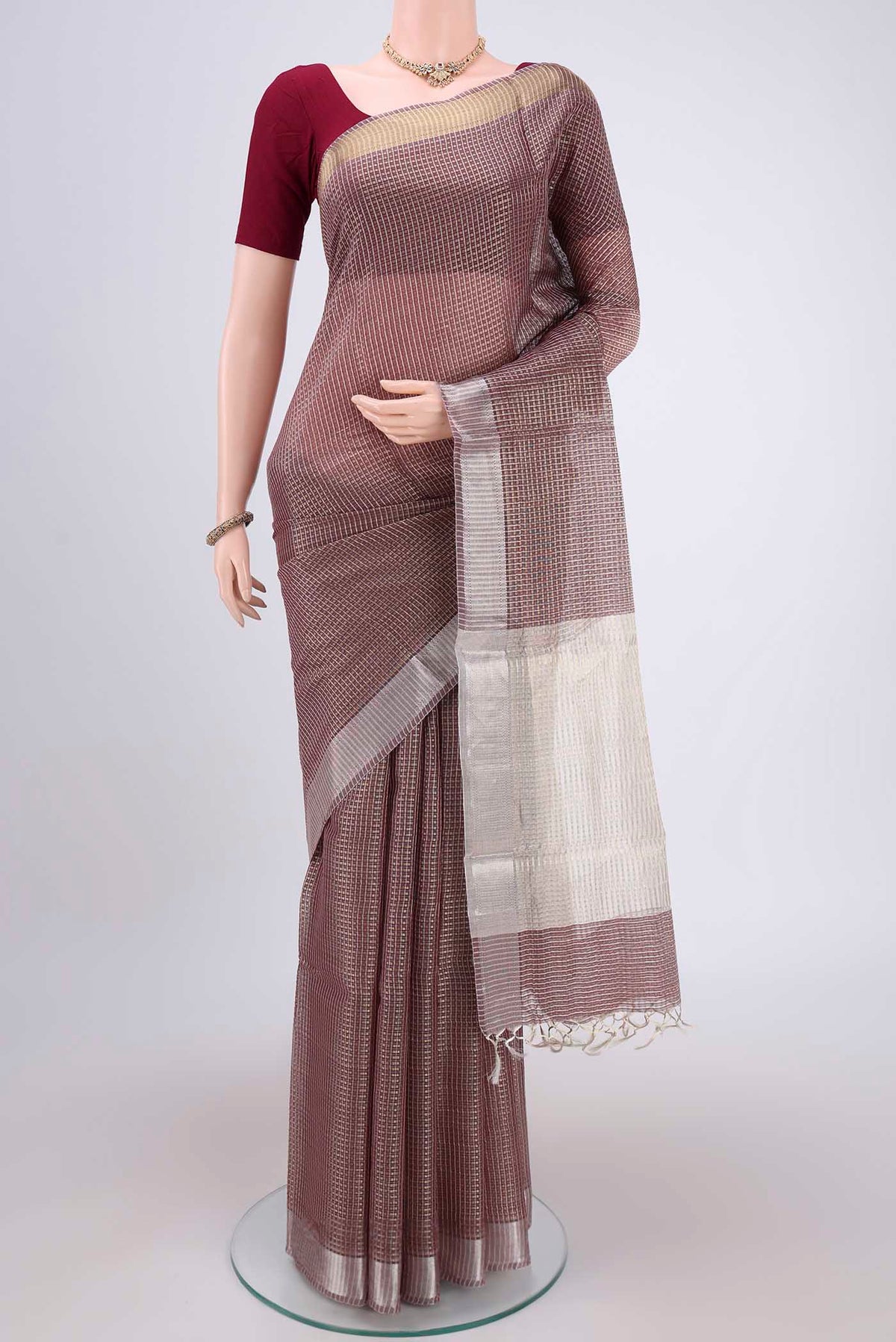 Brown MP Tussar Saree with Checked design on the body and Temple Border.  displayed on a mannequin