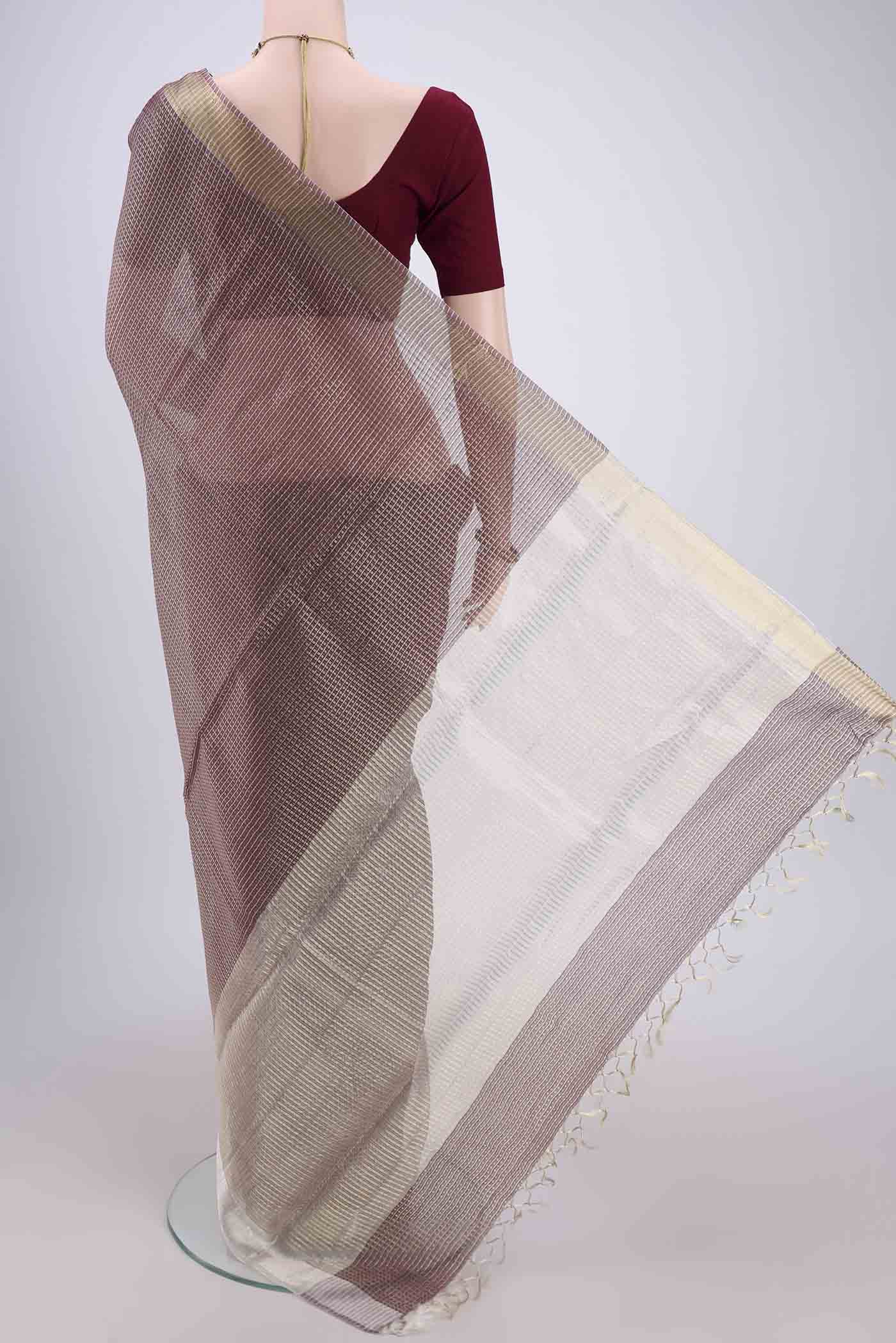 Flat view of Brown MP Tussar Saree with Checked design on the body and Temple Border. 