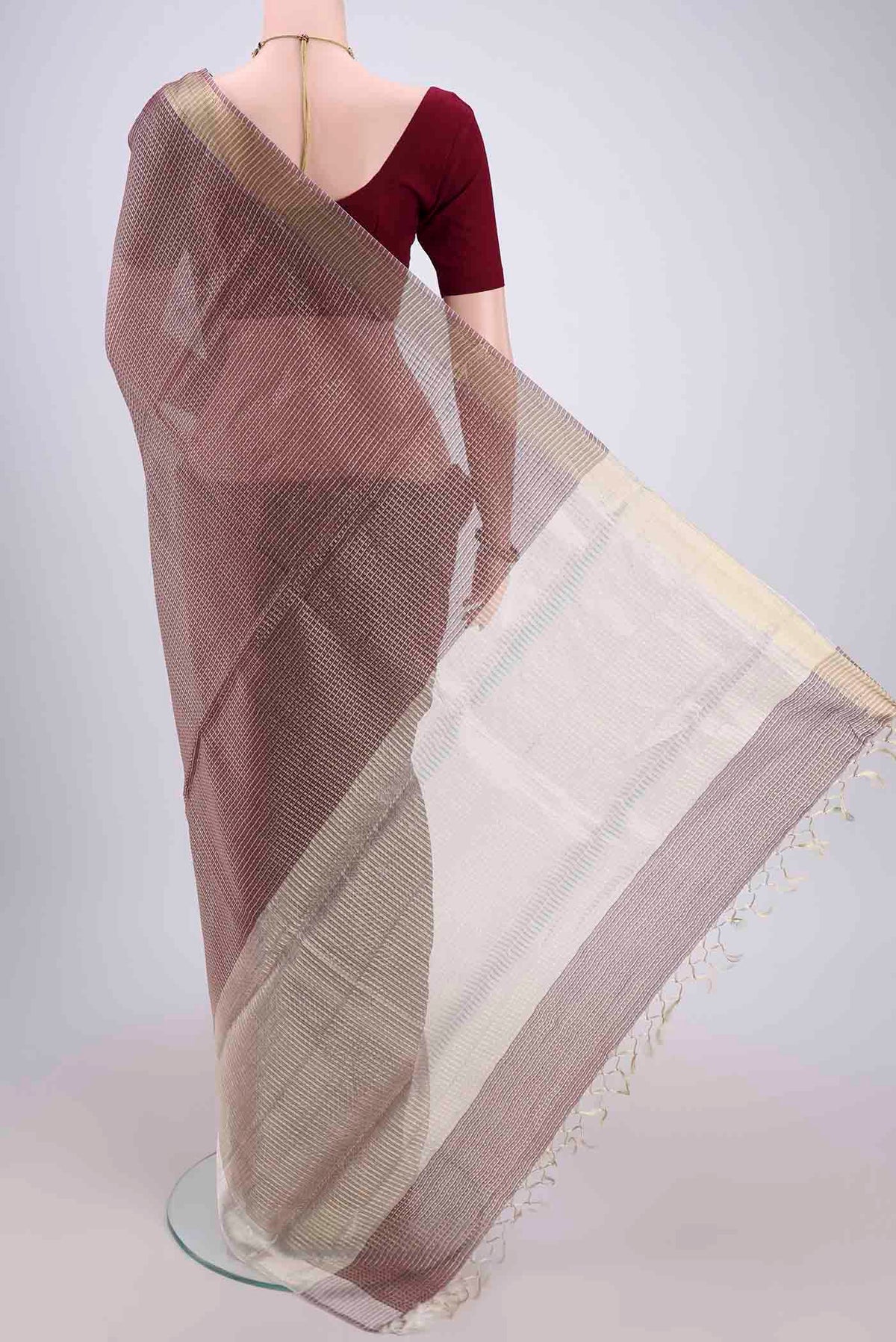 Flat view of Brown MP Tussar Saree with Checked design on the body and Temple Border. 