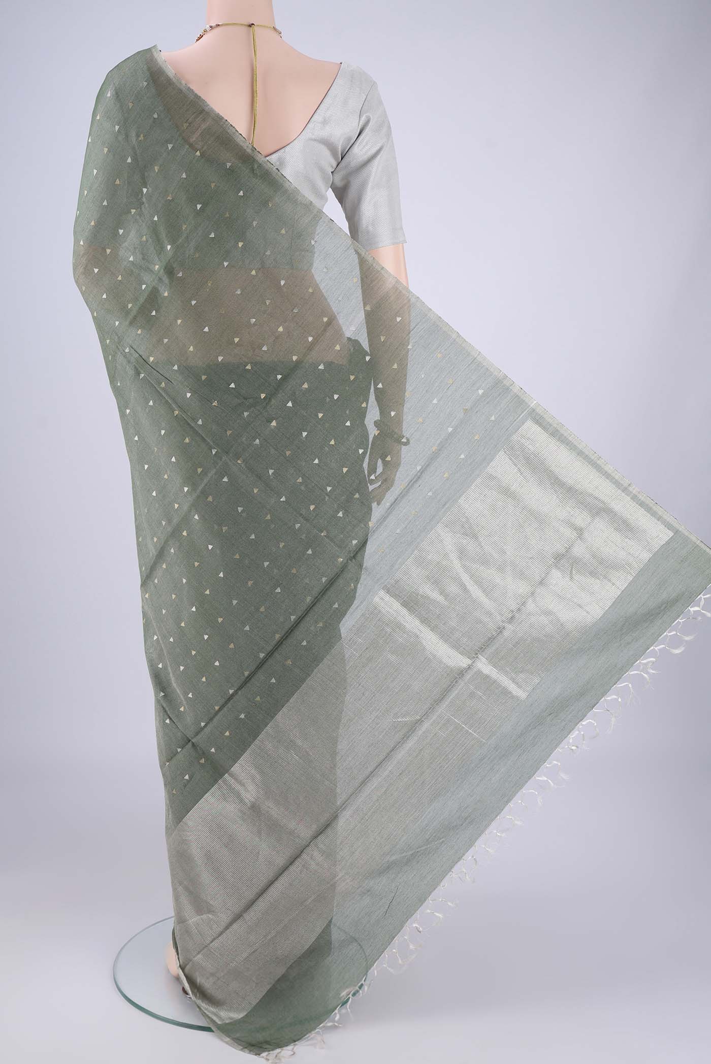 Flat view of Olive Green MP Tussar Saree with Zari Butta on the body and Thin Zari Line. 