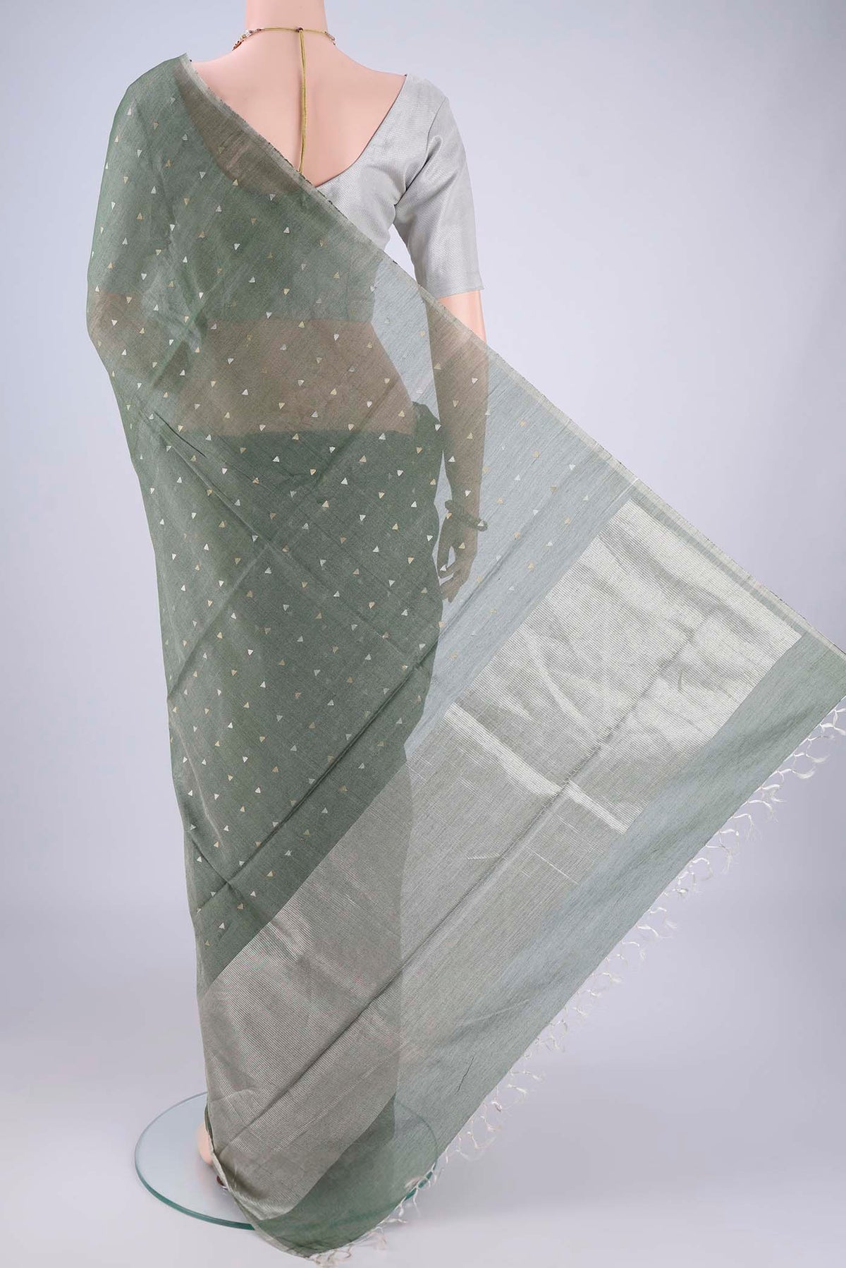 Flat view of Olive Green MP Tussar Saree with Zari Butta on the body and Thin Zari Line. 