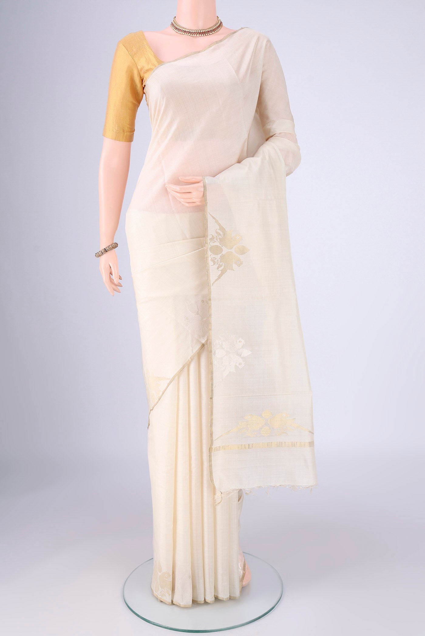 Off White MP Tussar Saree with Plain Body and Zari Border.  displayed on a mannequin