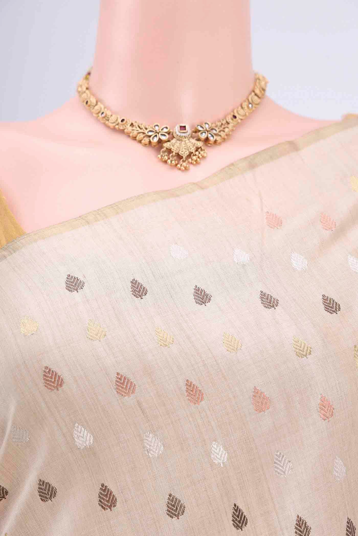 Border image of Beige Tussar Silk Saree with Zari And Thread Butta on the body and Thin Zari Line. 