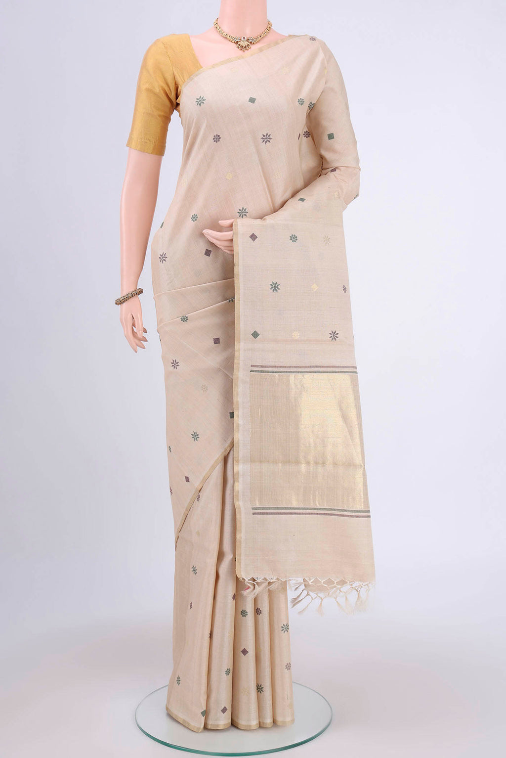 Beige Tussar Silk Saree with Zari And Thread Butta on the body and Thin Zari Line.  displayed on a mannequin