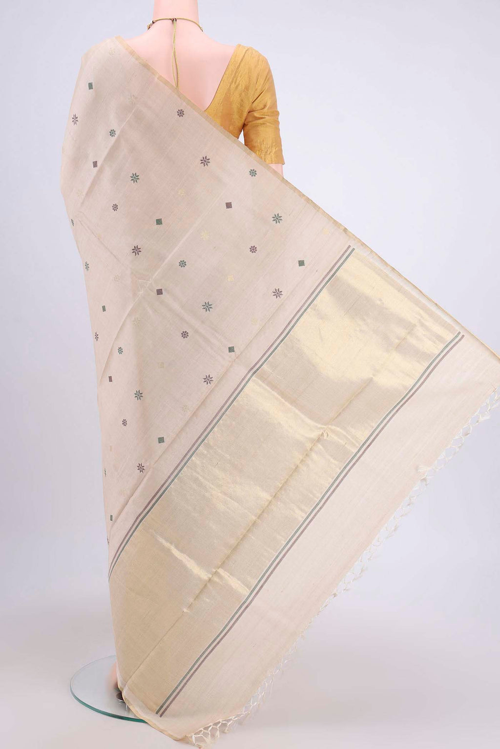 Flat view of Beige Tussar Silk Saree with Zari And Thread Butta on the body and Thin Zari Line. 