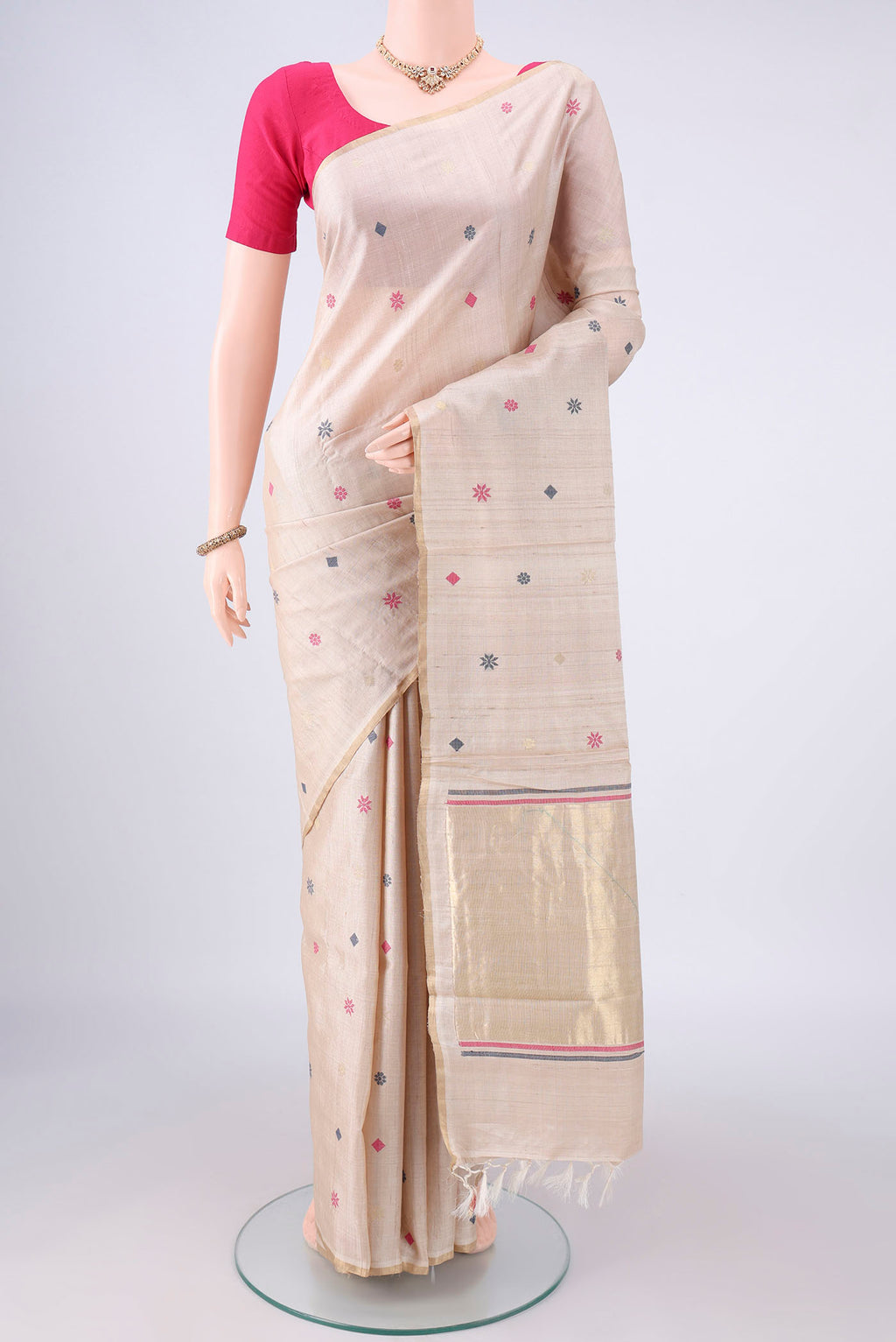 Beige MP Tussar Saree with Thread Butta on the body and Zari Border.  displayed on a mannequin