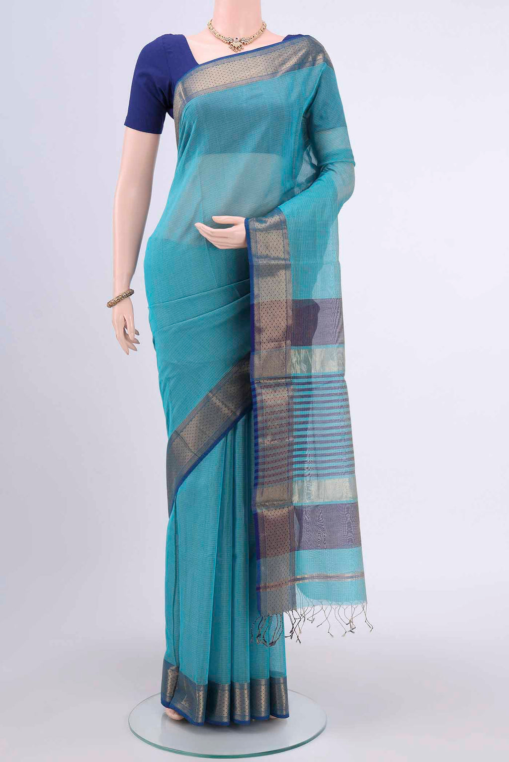 Turquoise Tussar Silk Saree with Thread Butta on the body and Zari Border.  displayed on a mannequin