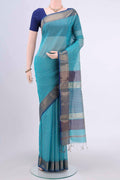 Turquoise Tussar Silk Saree with Thread Butta on the body and Zari Border.  displayed on a mannequin