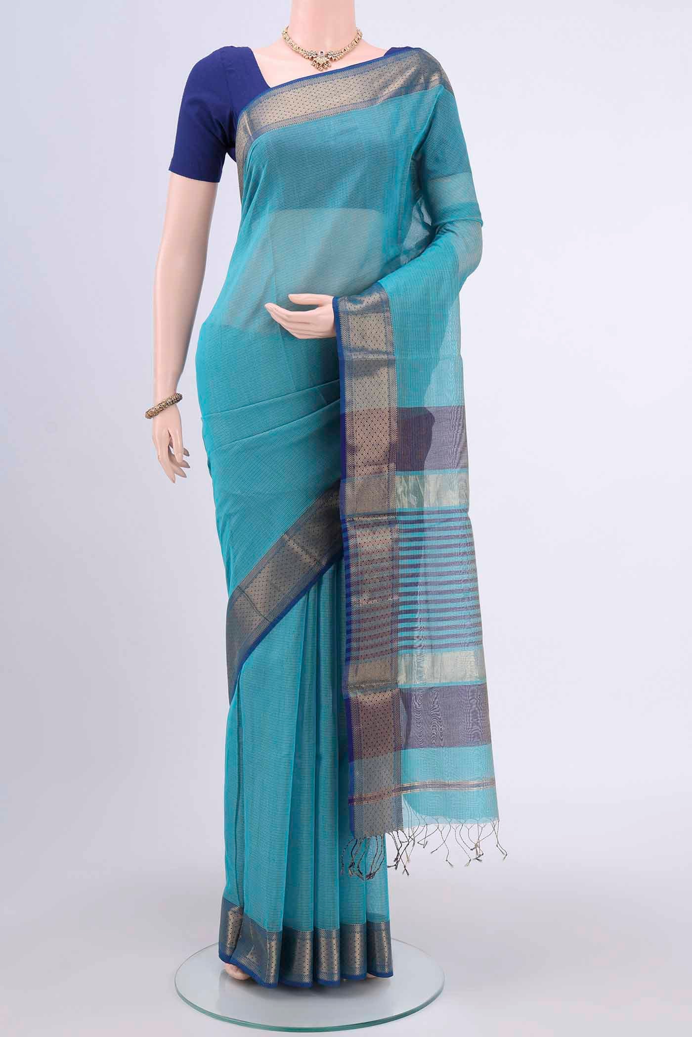 Turquoise Tussar Silk Saree with Thread Butta on the body and Zari Border.  displayed on a mannequin