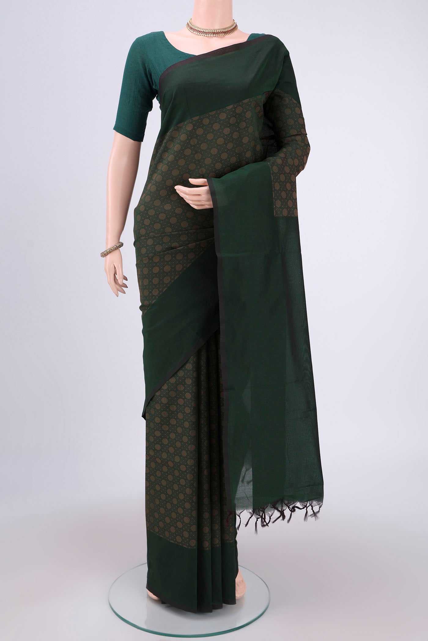 Green Blended Poly Cotton Saree with Jacquard design on the body and Plain Border.  displayed on a mannequin