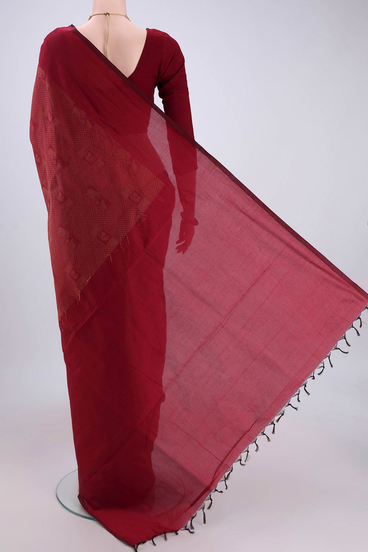 Flat view of Maroon Blended Poly Cotton Saree with Jacquard design on the body and Plain Border. 