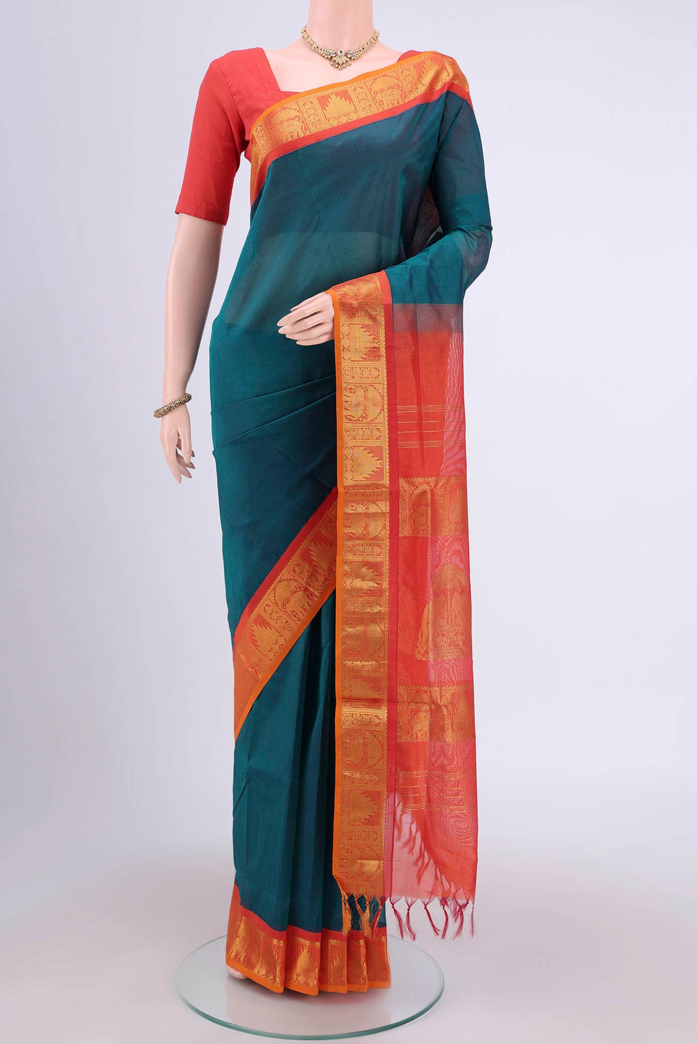 Peacock Blue Silk Cotton Saree with Plain Body and Zari Border.  displayed on a mannequin
