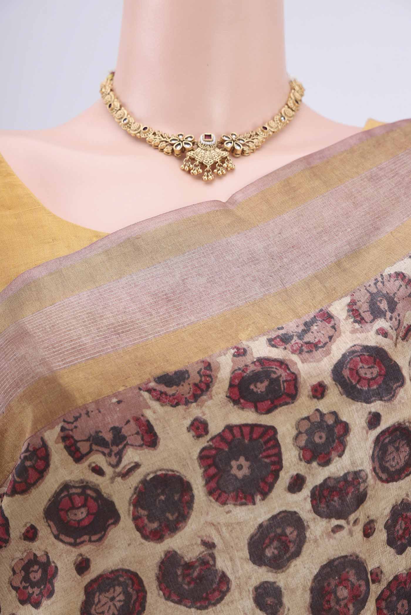 Border image of Beige Tussar Silk Saree with kalamkari Print on the body and Zari Border. 