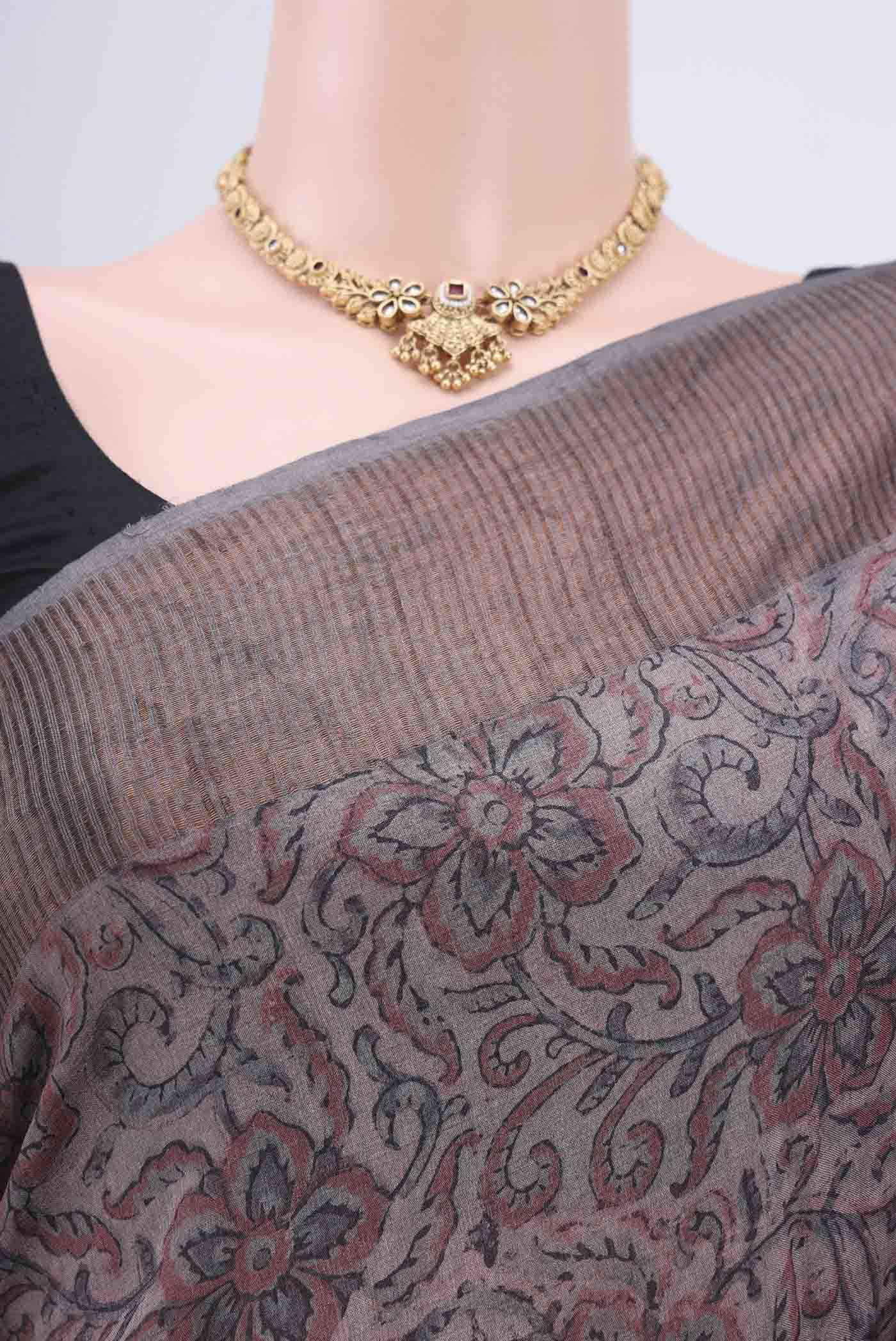 Border image of Dark Mauve Tussar Silk Saree with kalamkari Print on the body and Zari Border. 