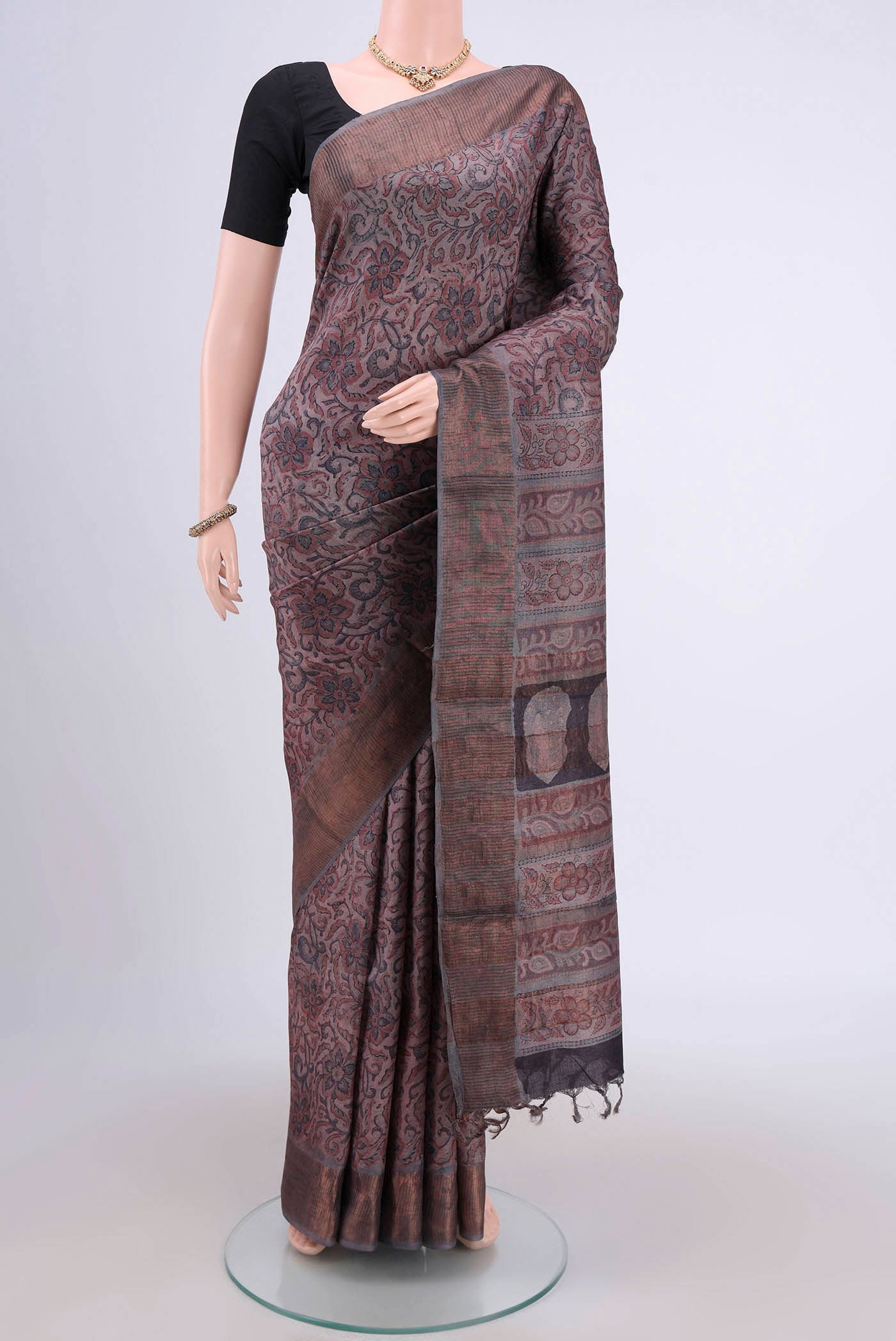 Dark Mauve Tussar Silk Saree with kalamkari Print on the body and Zari Border.  displayed on a mannequin