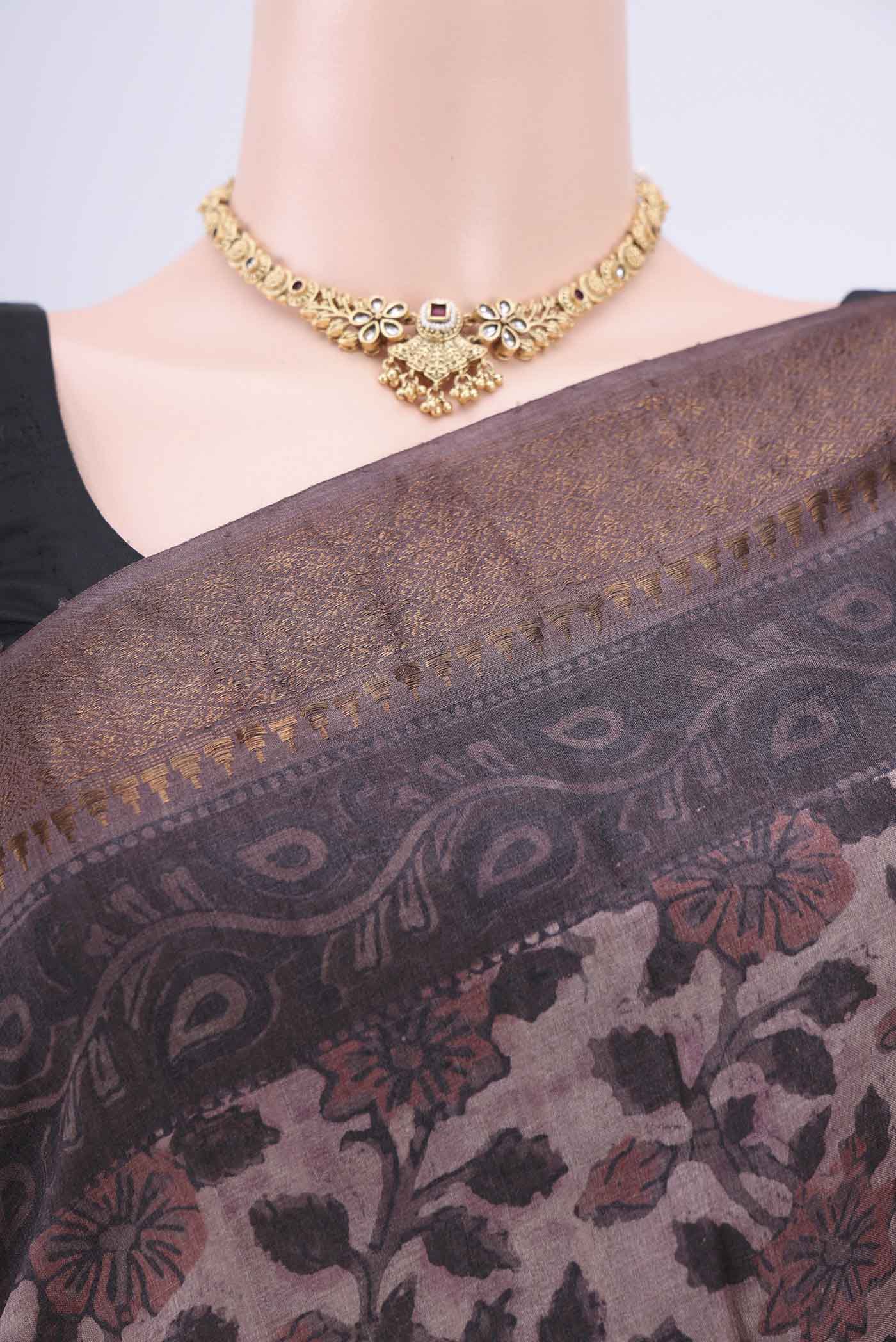 Border image of Dark Mauve Tussar Silk Saree with kalamkari Print on the body and Zari Border. 