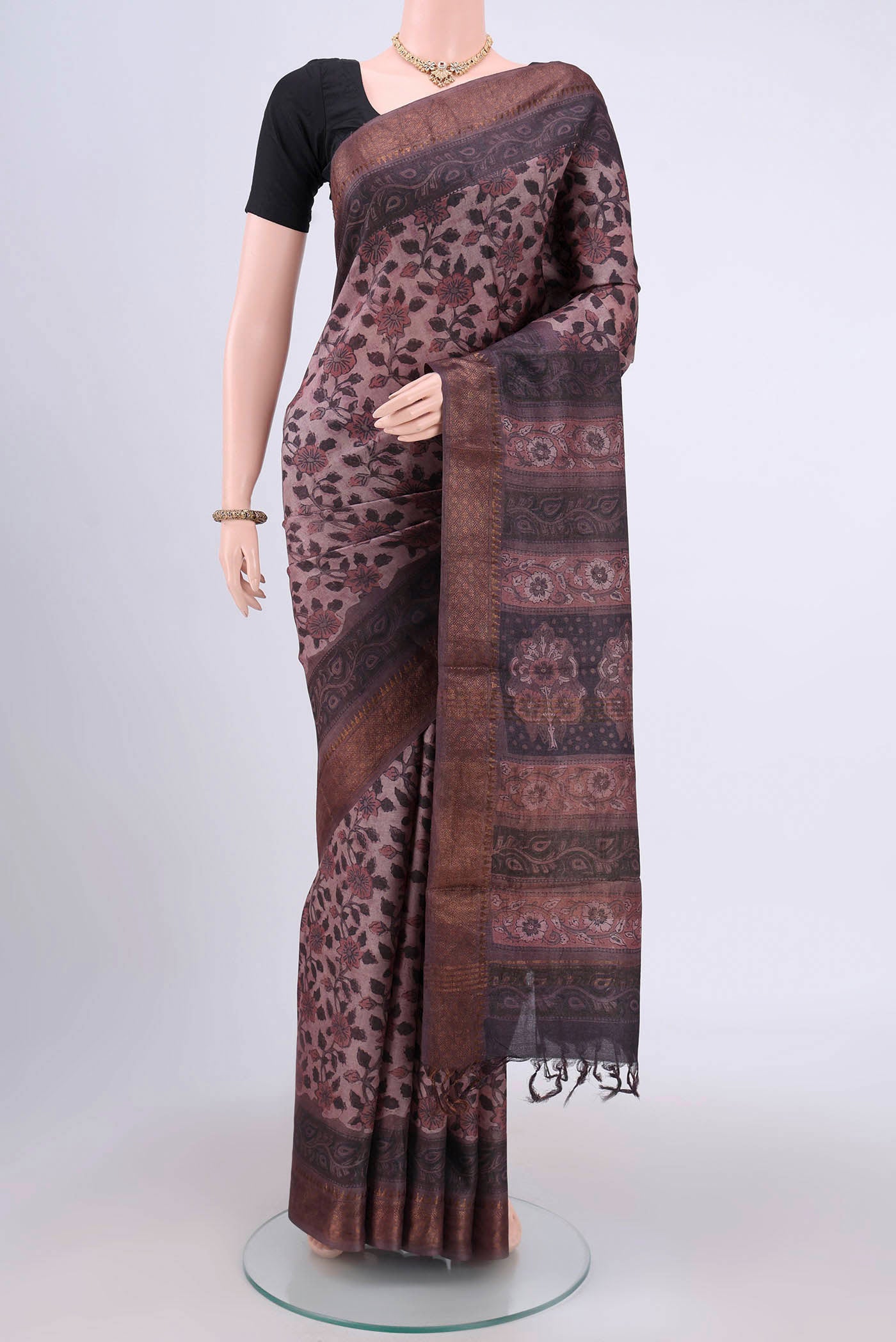Dark Mauve Tussar Silk Saree with kalamkari Print on the body and Zari Border.  displayed on a mannequin
