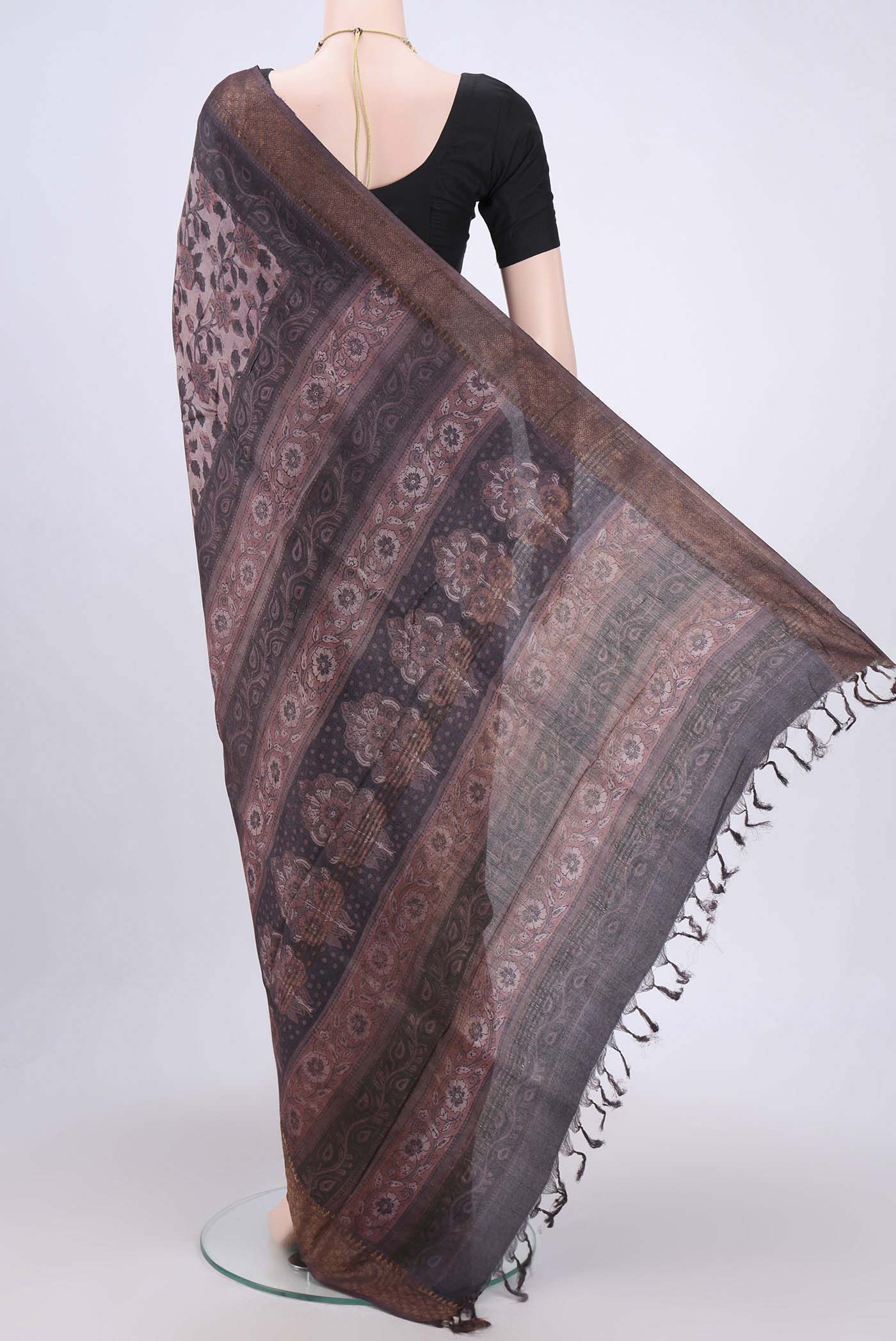 Flat view of Dark Mauve Tussar Silk Saree with kalamkari Print on the body and Zari Border. 