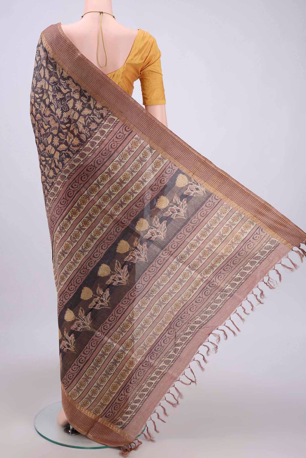 Flat view of Davys Grey Tussar Silk Saree with kalamkari Print on the body and Zari Border. 