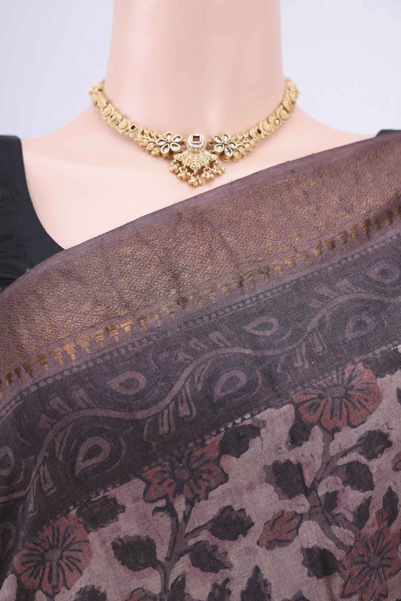 Border image of Brown Tussar Silk Saree with Floral Print on the body and Zari Border. 