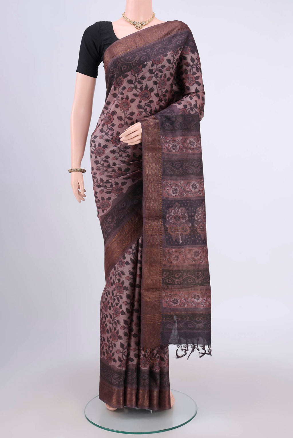 Brown Tussar Silk Saree with Floral Print on the body and Zari Border.  displayed on a mannequin