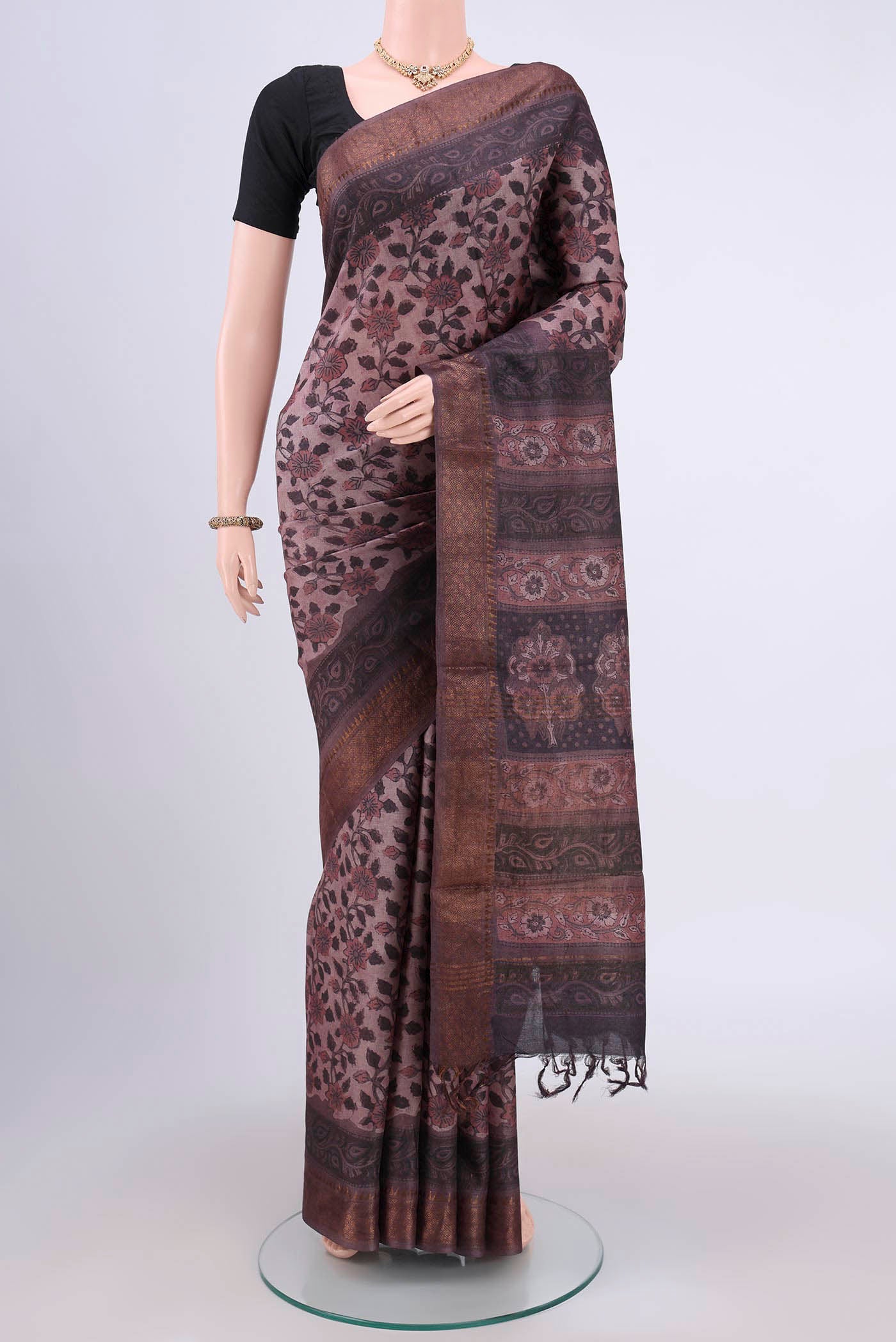 Brown Tussar Silk Saree with Floral Print on the body and Zari Border.  displayed on a mannequin
