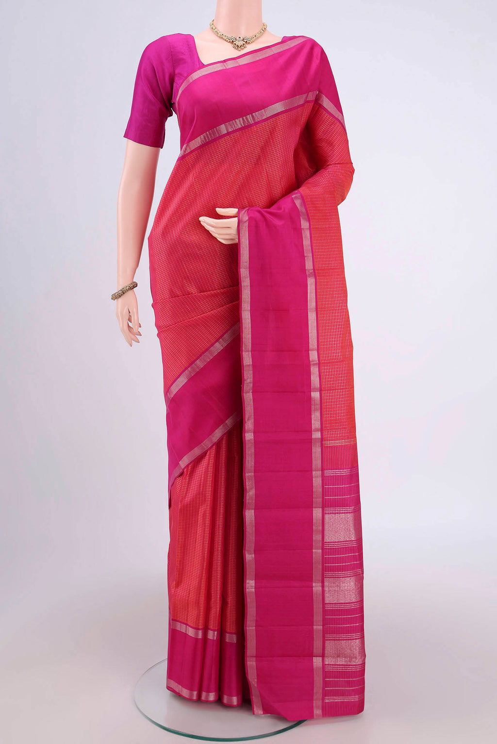 Dark Pink Kanchipuram Silk Saree with Checked design on the body and Zari Border.  displayed on a mannequin